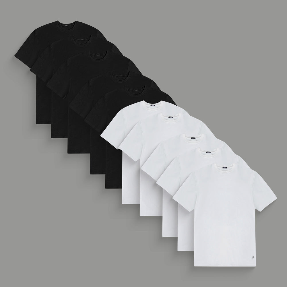 Eight plain t-shirts, four black and four white, arranged in alternating colors.