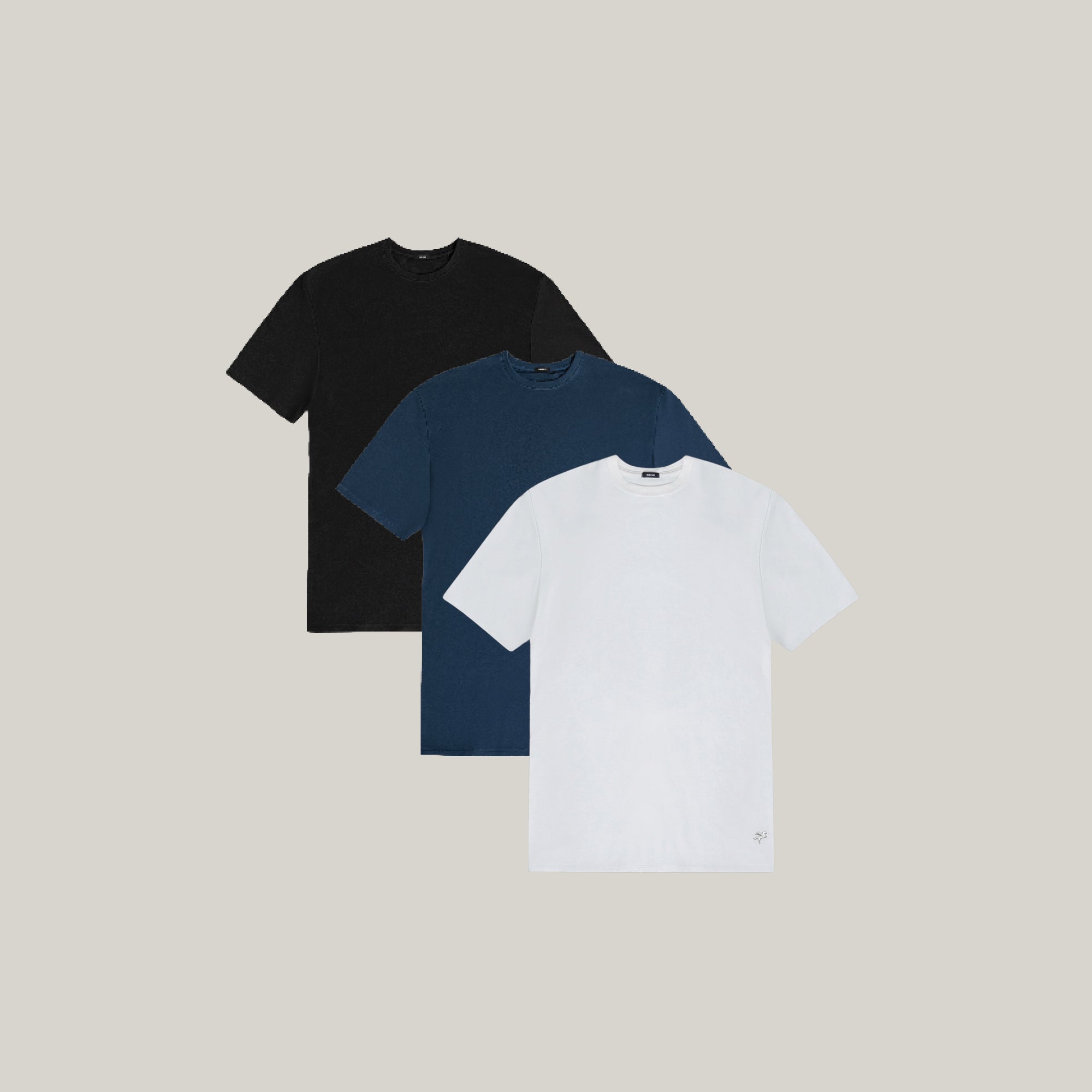 Three t-shirts in black, blue, and white on a beige background model Tyler in Shade
