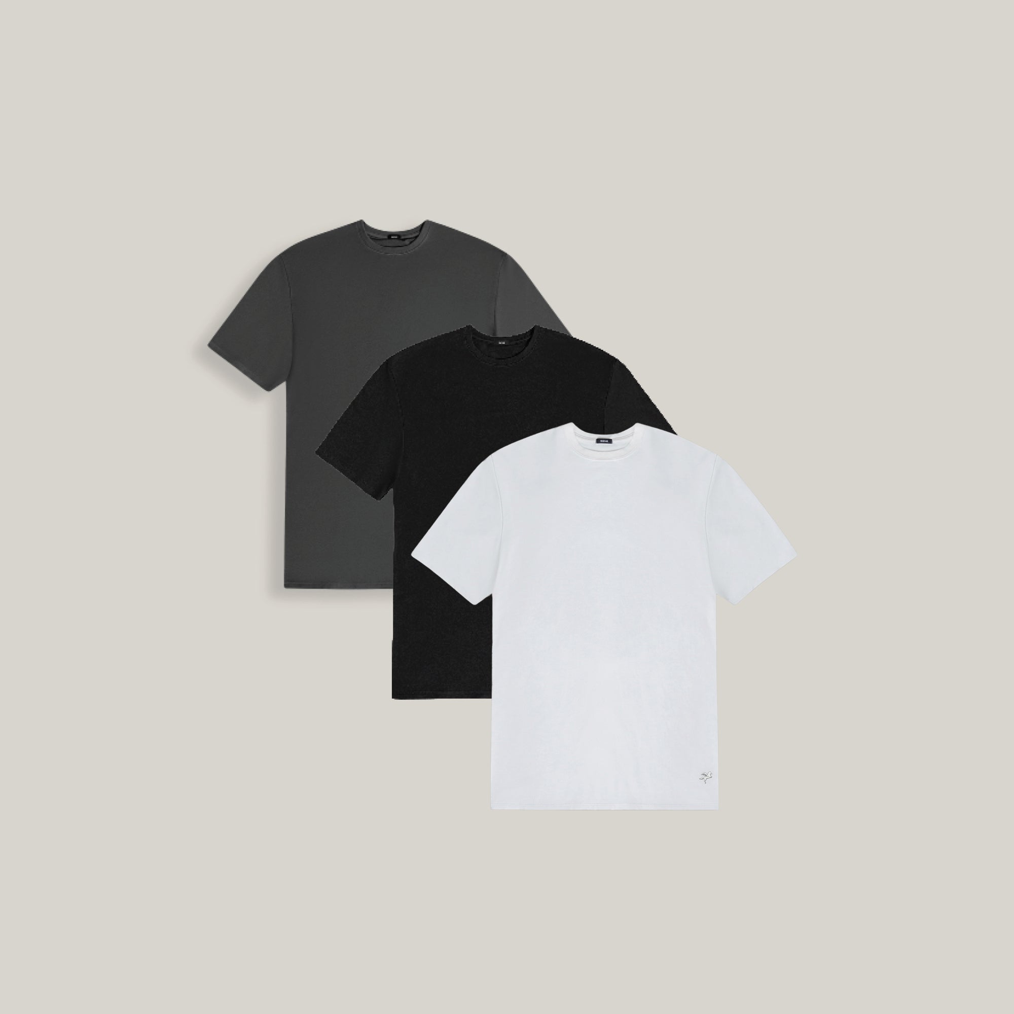 Three t-shirts in black, gray, and white on a beige background model Tyler in Minimalist