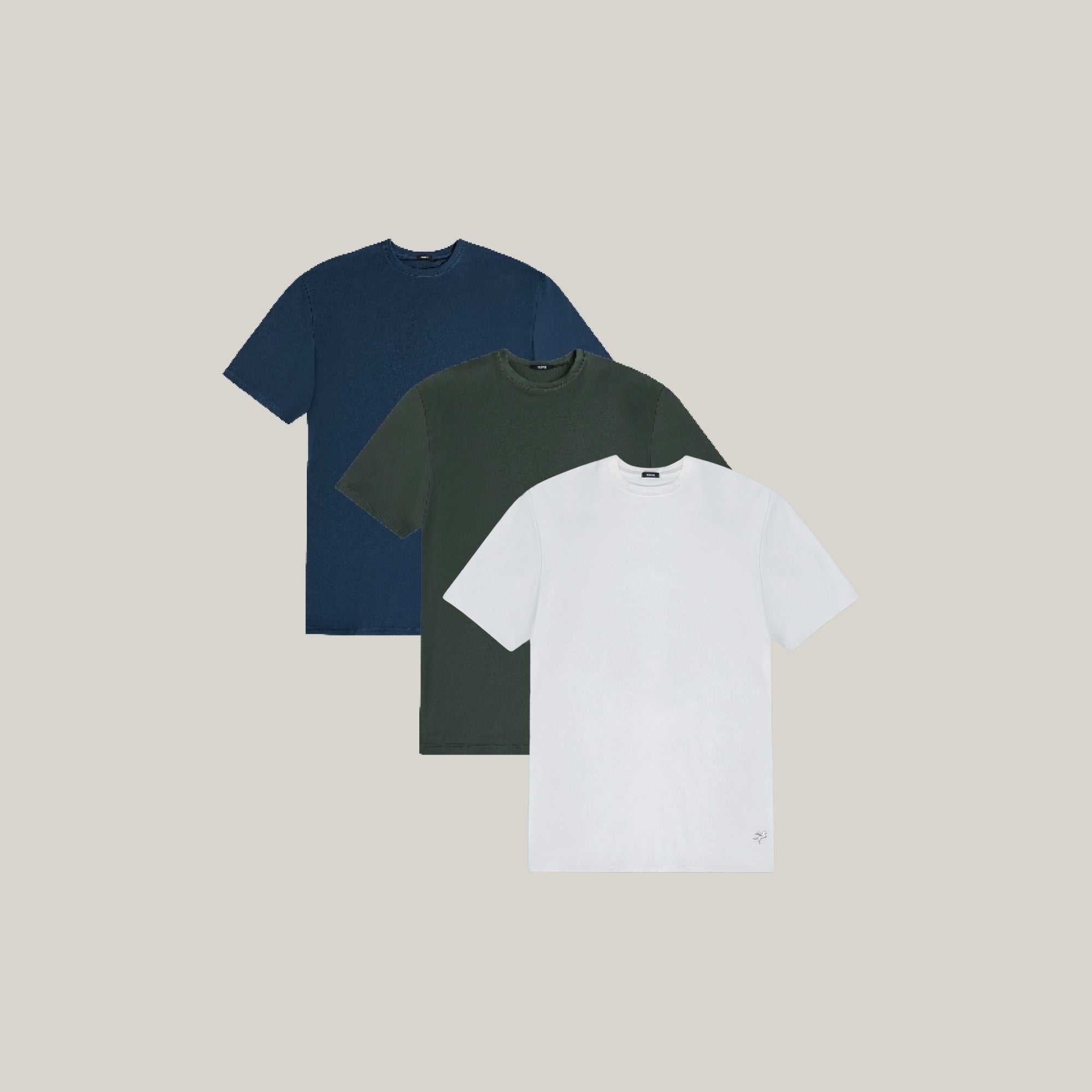 Three t-shirts in blue, green, and white on a beige background model Tyler in Coastal
