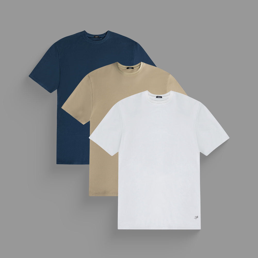 Three stacked t-shirts in navy, beige, and white on a gray background.