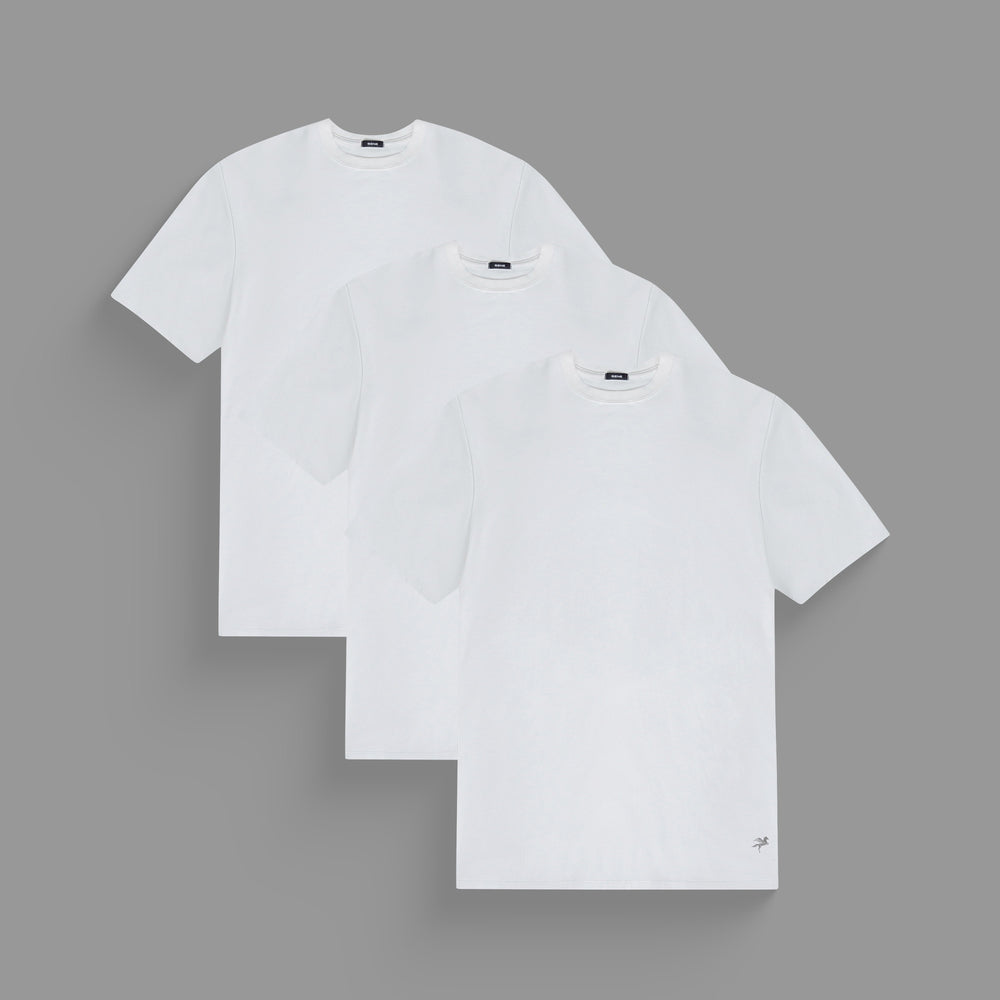 Three plain white t-shirts on a gray background.