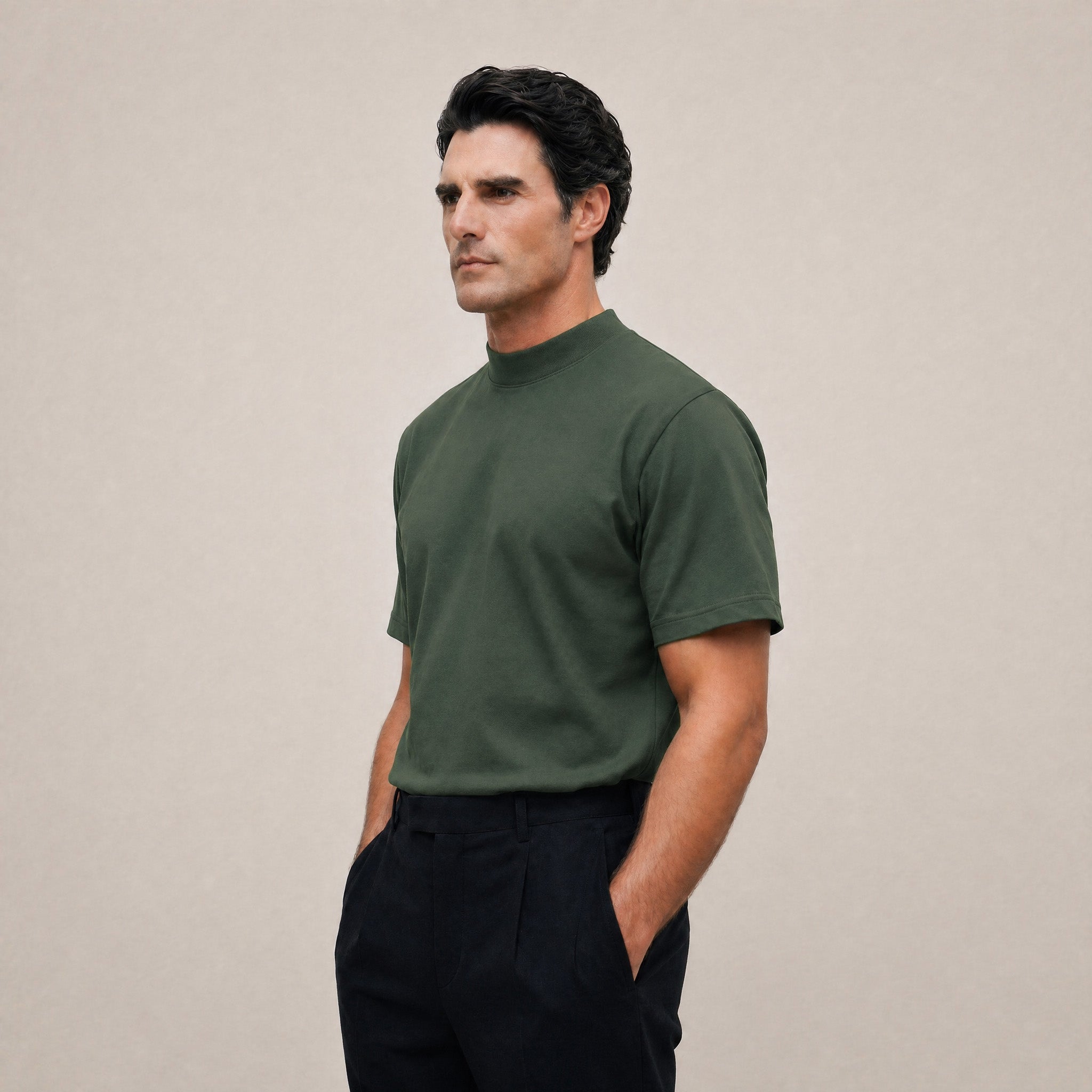Man wearing a Moss short-sleeve shirt against a beige background model Kive in Moss