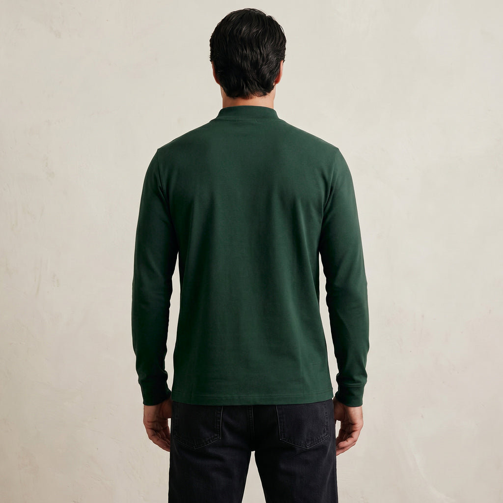 Man wearing a Pine Grove long-sleeve shirt against a beige background model Kive in Pine Grove