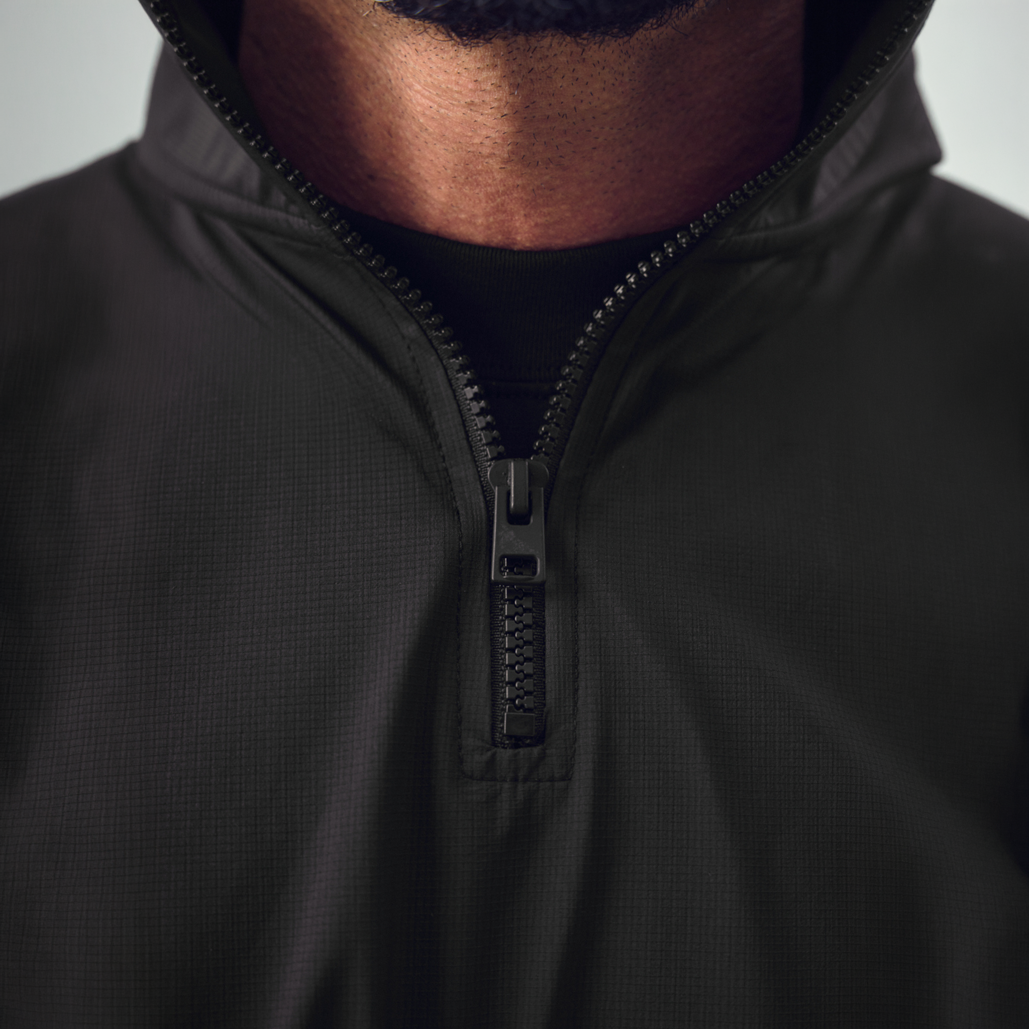 bespoke custom-fit golf nylon rain shell water resistant wind breaker quarter zip model chad in black