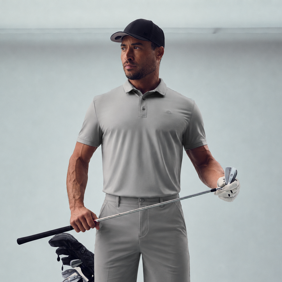 Man custom-fit gray golf attire holding a golf club model chad in glacier