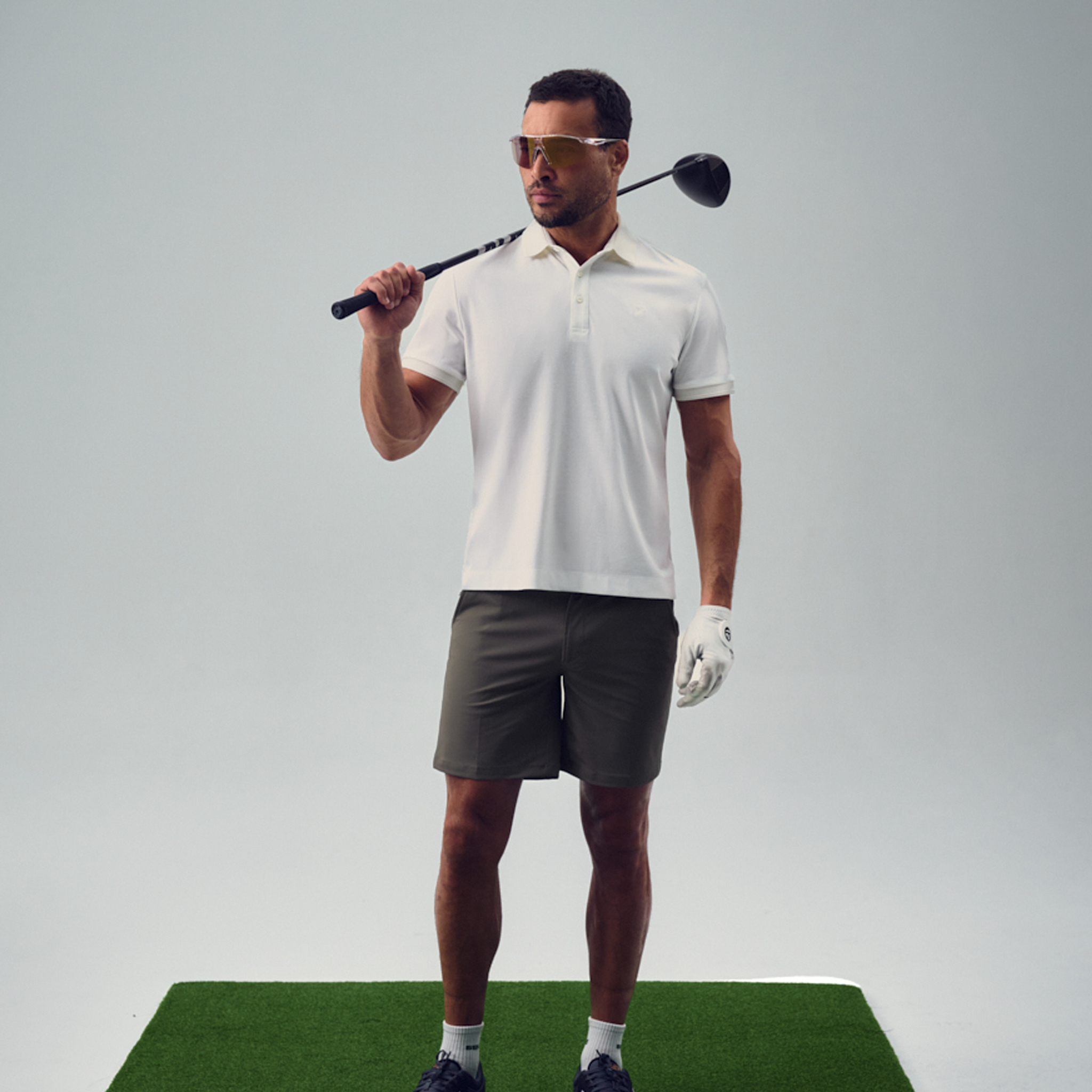 chad wearing bespoke golf polo model chad in white