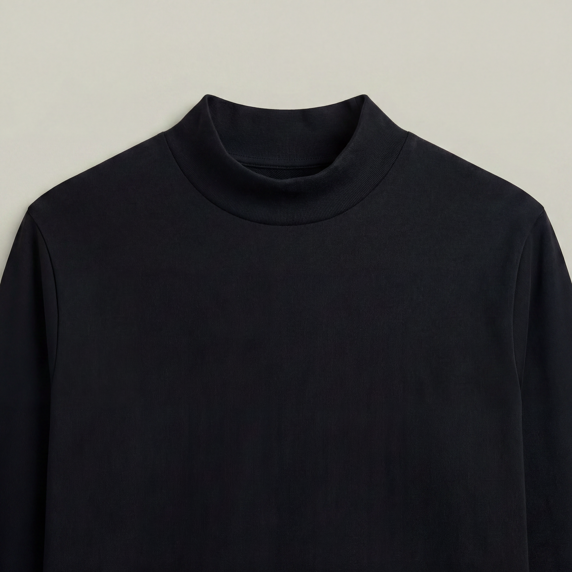 Black mockneck sweater on a beige background model kive in black