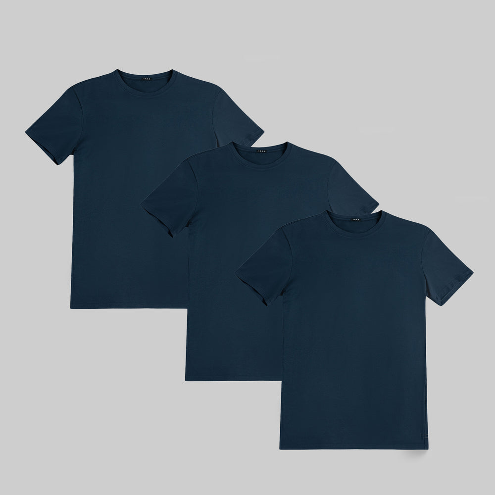 Three navy blue t-shirts arranged on a light gray background.