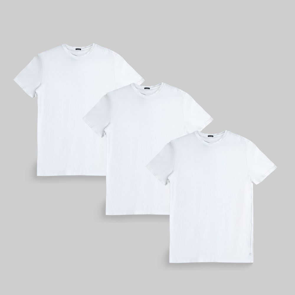 Three plain white T-shirts on a gray background.