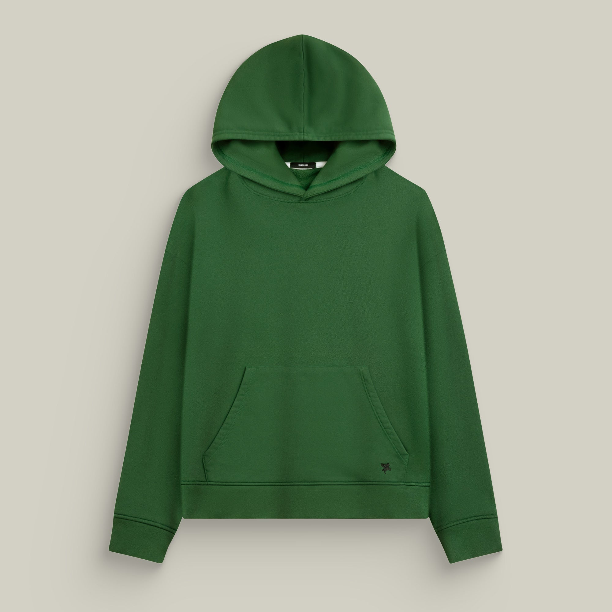 Green hoodie on a beige background Man wearing a green hoodie against a beige background model Kive in Eden