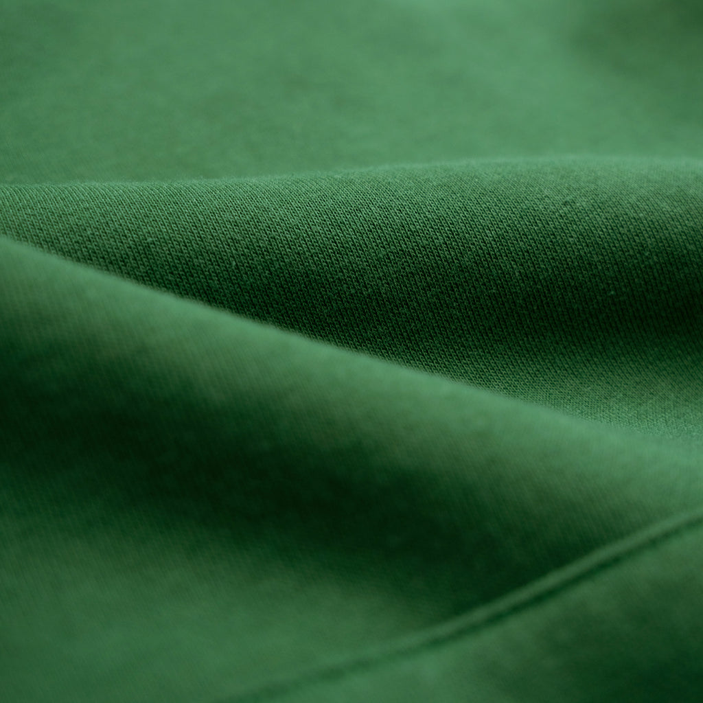 Close-up of green fabric with folds model Kive in Eden