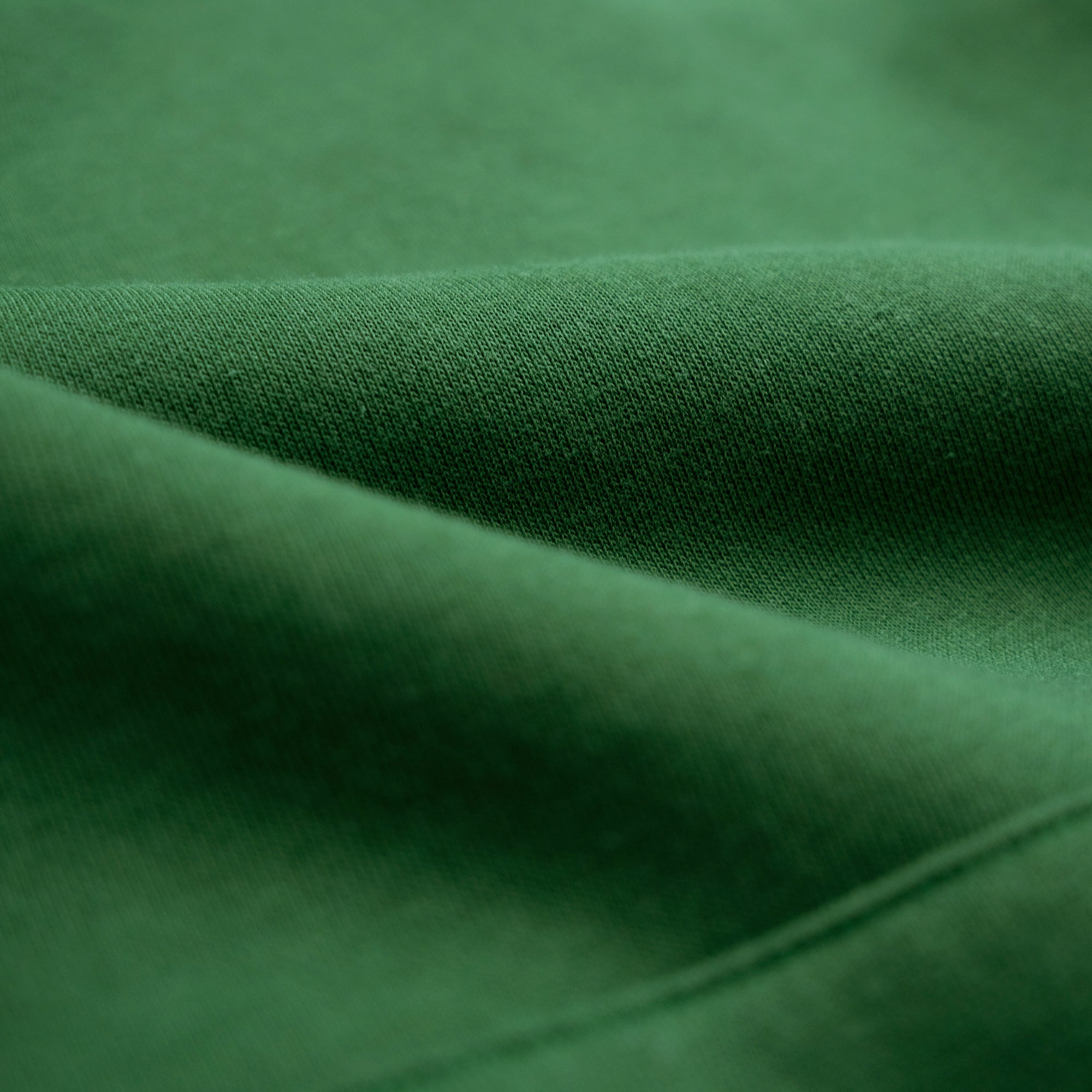 Close-up of green fabric with folds model Kive in Eden