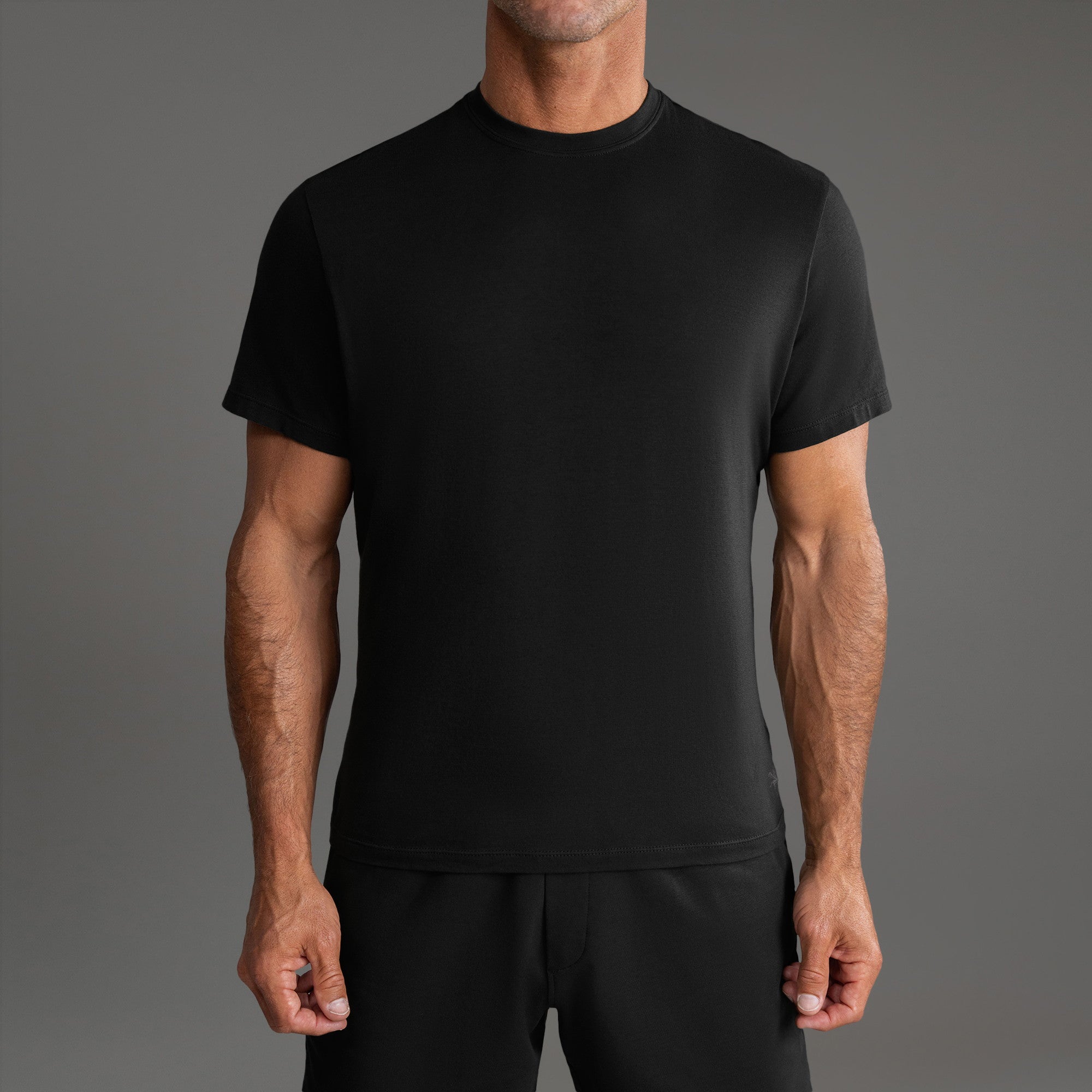 Three t-shirts in black, blue, and white on a beige background model Tyler in Shade