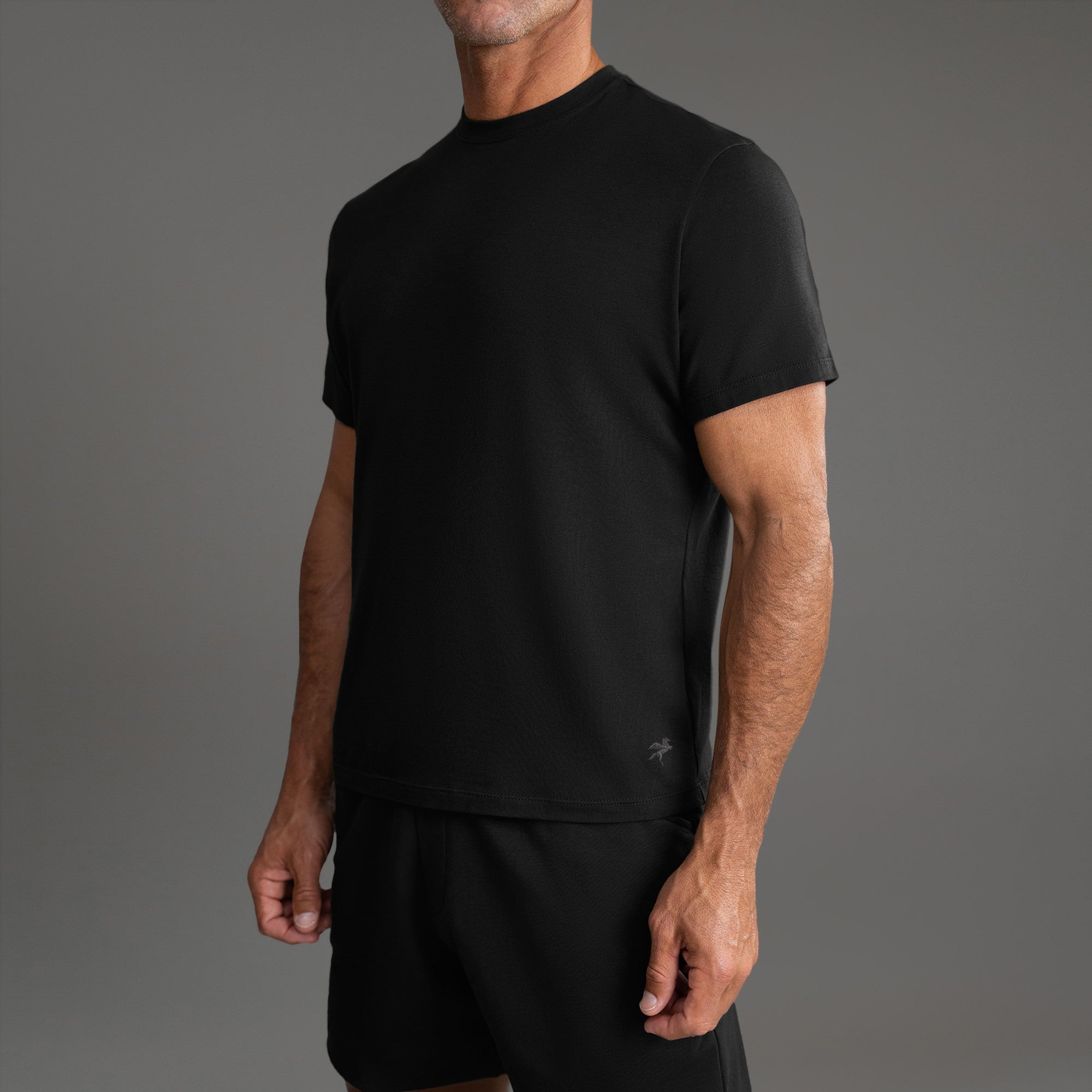 Three t-shirts in black, blue, and white on a beige background model Tyler in Shade