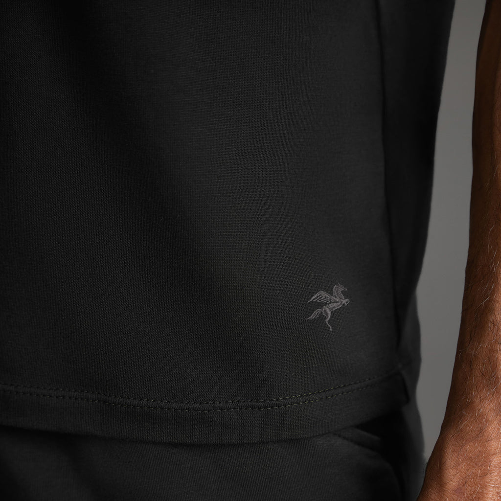 Three t-shirts in black, blue, and white on a beige background model Tyler in Shade