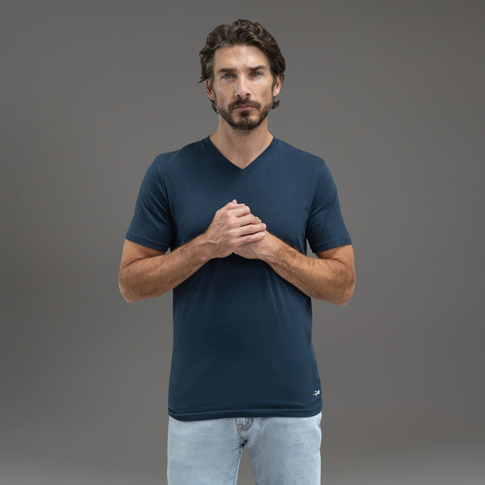 Man wearing a light gray V-neck T-shirt against a neutral background.