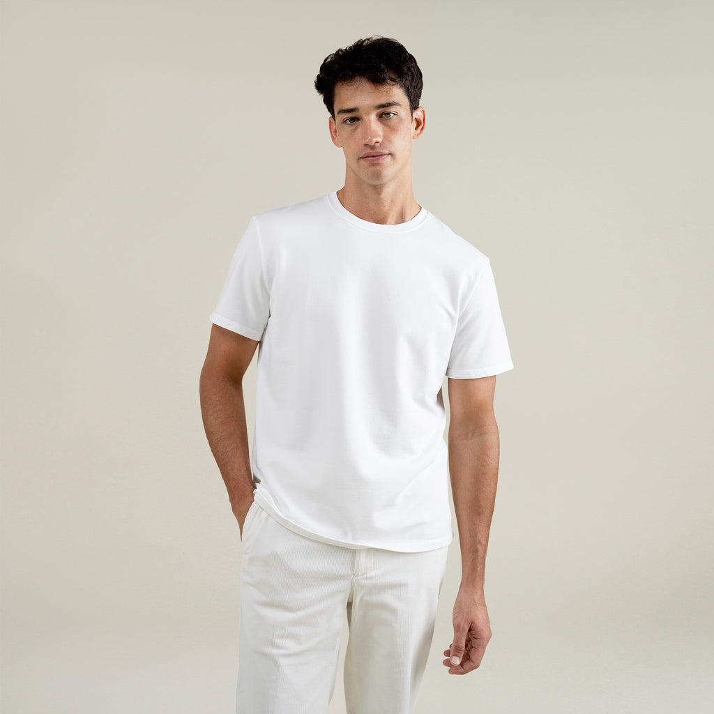 Three t-shirts in black, blue, and white on a beige background model Jessey in Shade