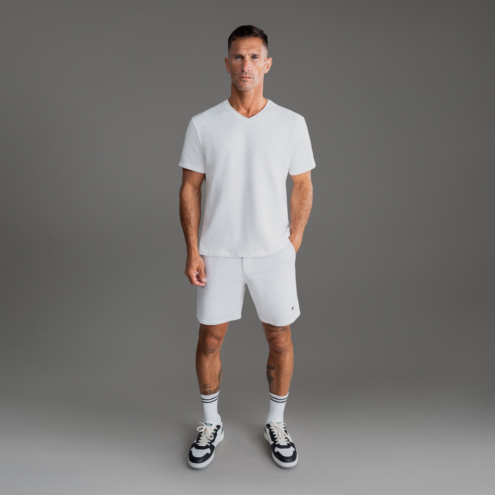 Cumulus v-neck t-shirt on a beige background model Tyler in Minimalist
