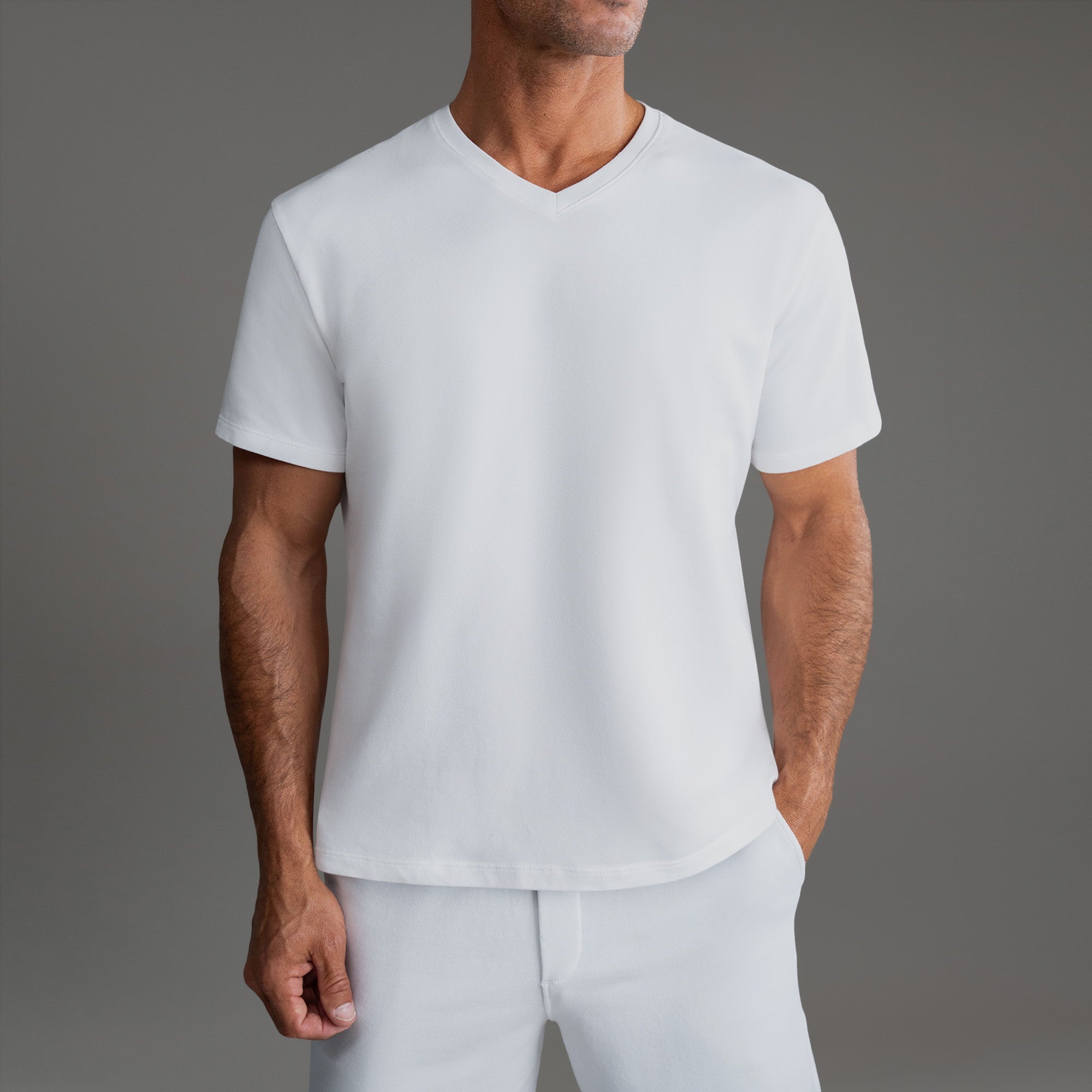 Cumulus v-neck t-shirt on a beige background model Tyler in Minimalist