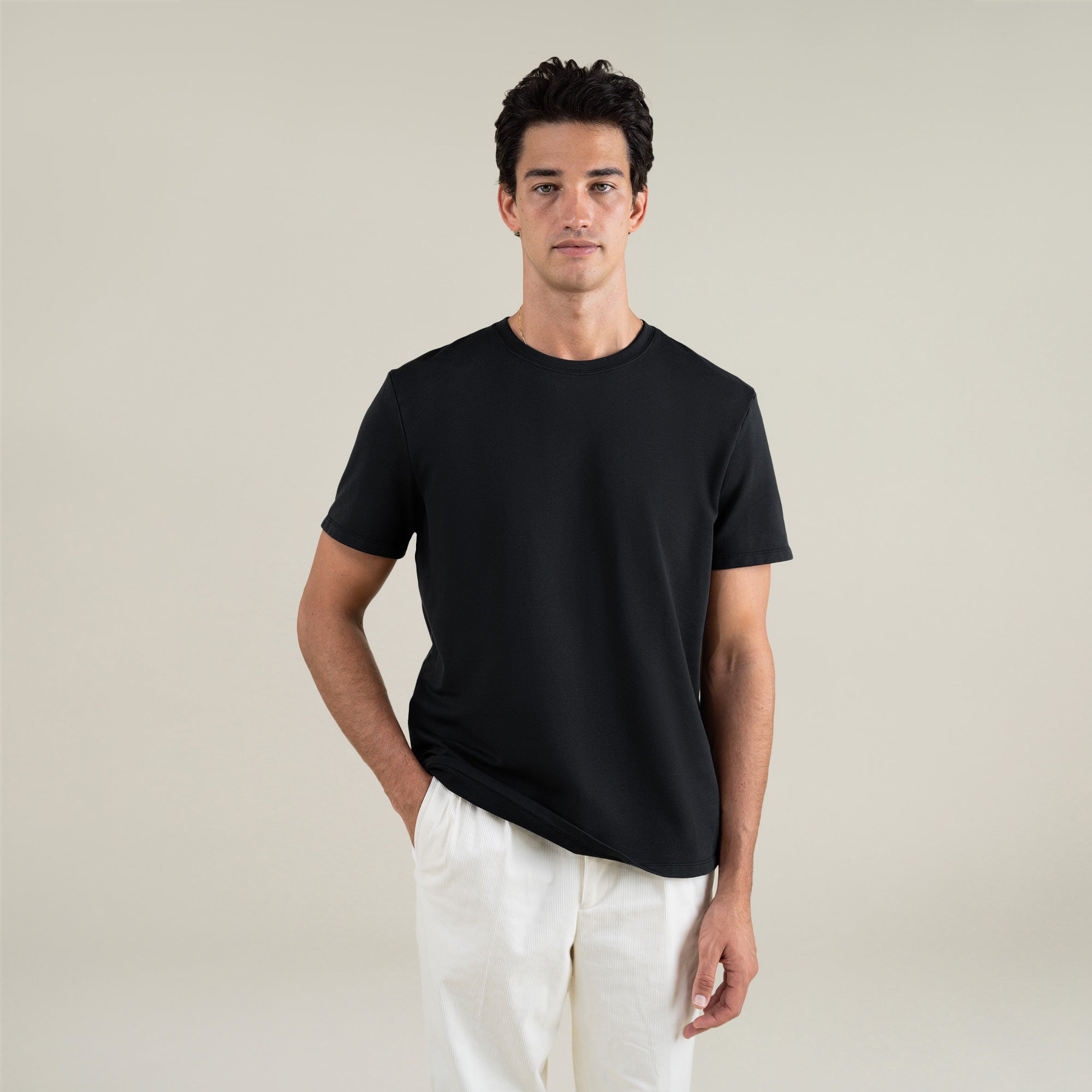 Three t-shirts in black, blue, and white on a beige background model Jessey in Shade