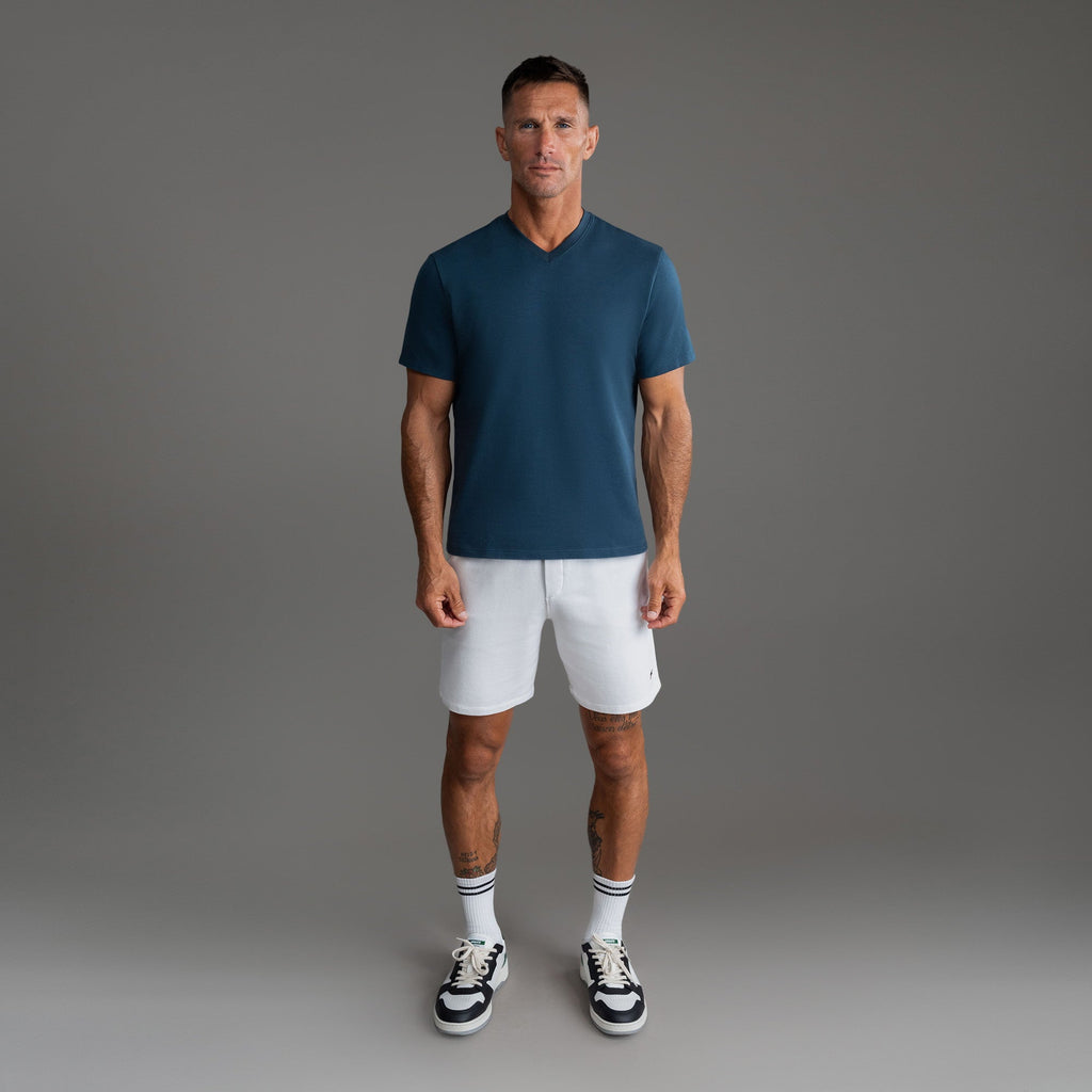 Cumulus v-neck t-shirt on a beige background model Tyler in Shade