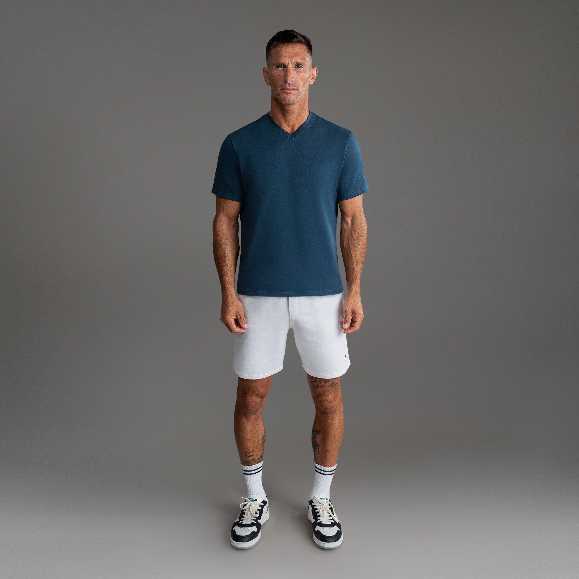 Cumulus v-neck t-shirt on a beige background model Tyler in Shade