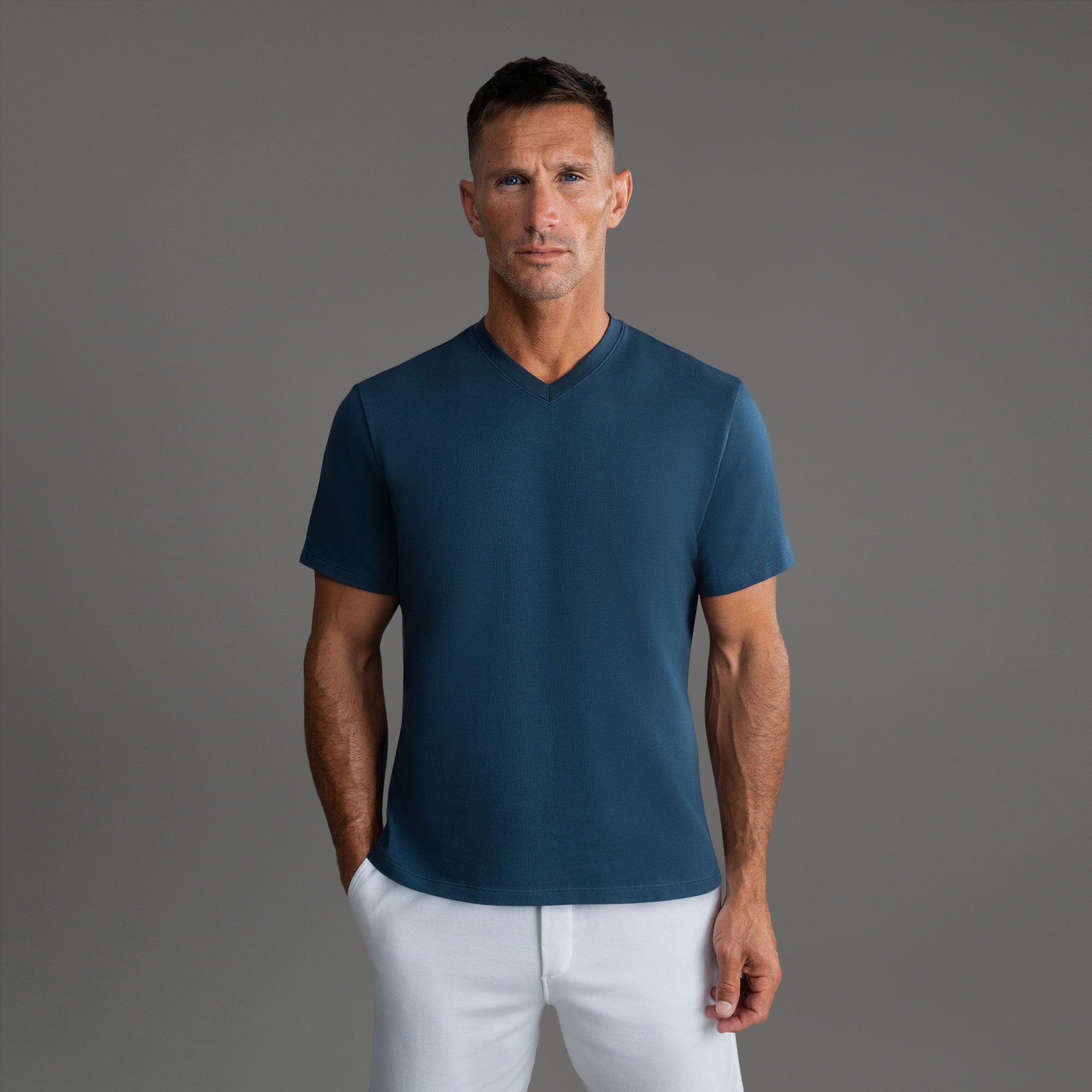 Cumulus v-neck t-shirt on a beige background model Tyler in Shade