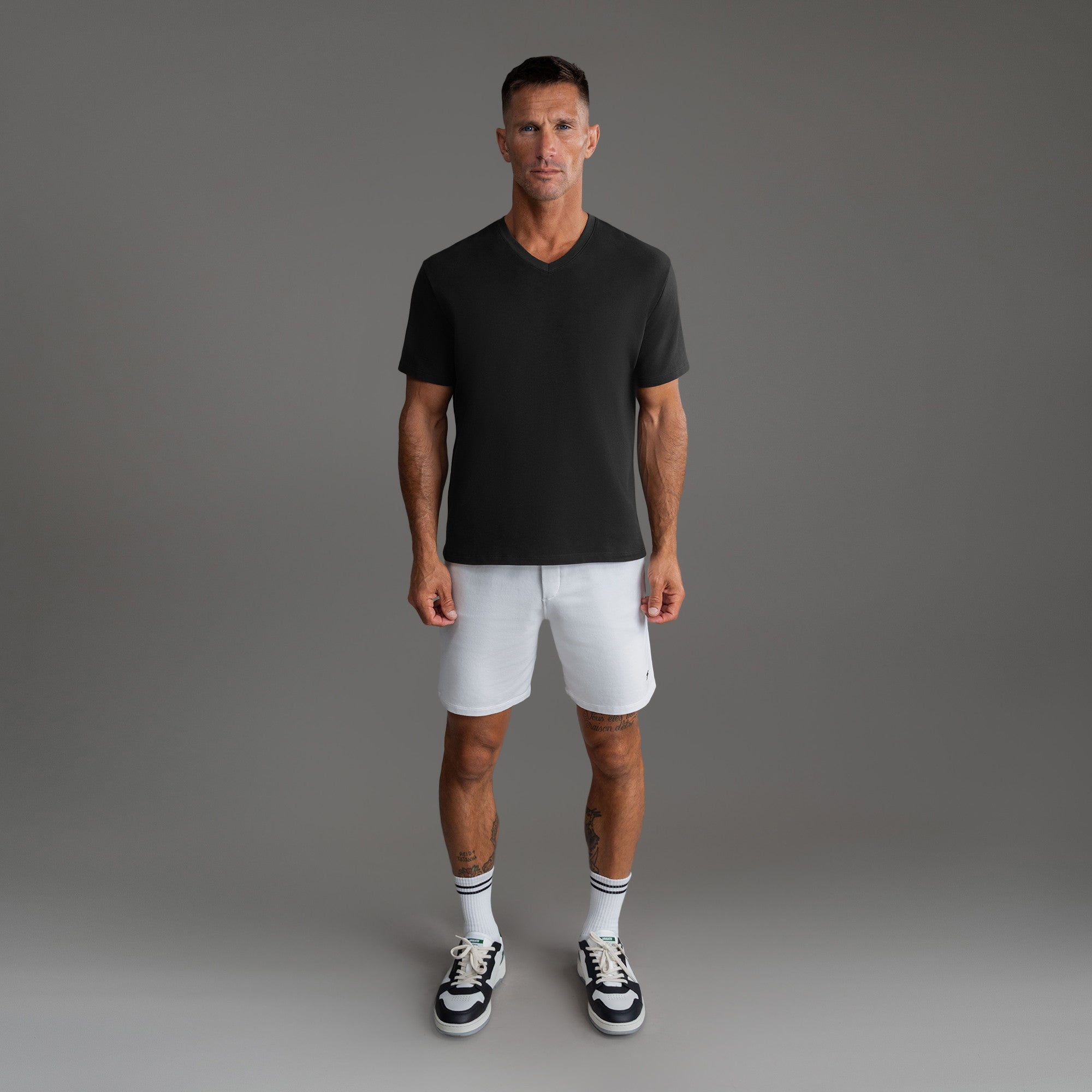 Cumulus v-neck t-shirt on a beige background model Tyler in Minimalist
