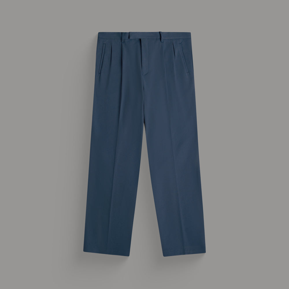 Blue pleated trousers displayed against a gray background.