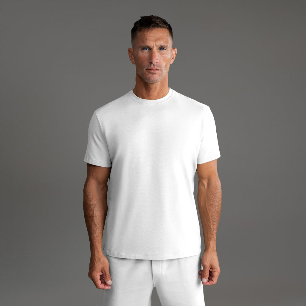 Six t-shirts in Black and White on a beige background model Tyler in Essential