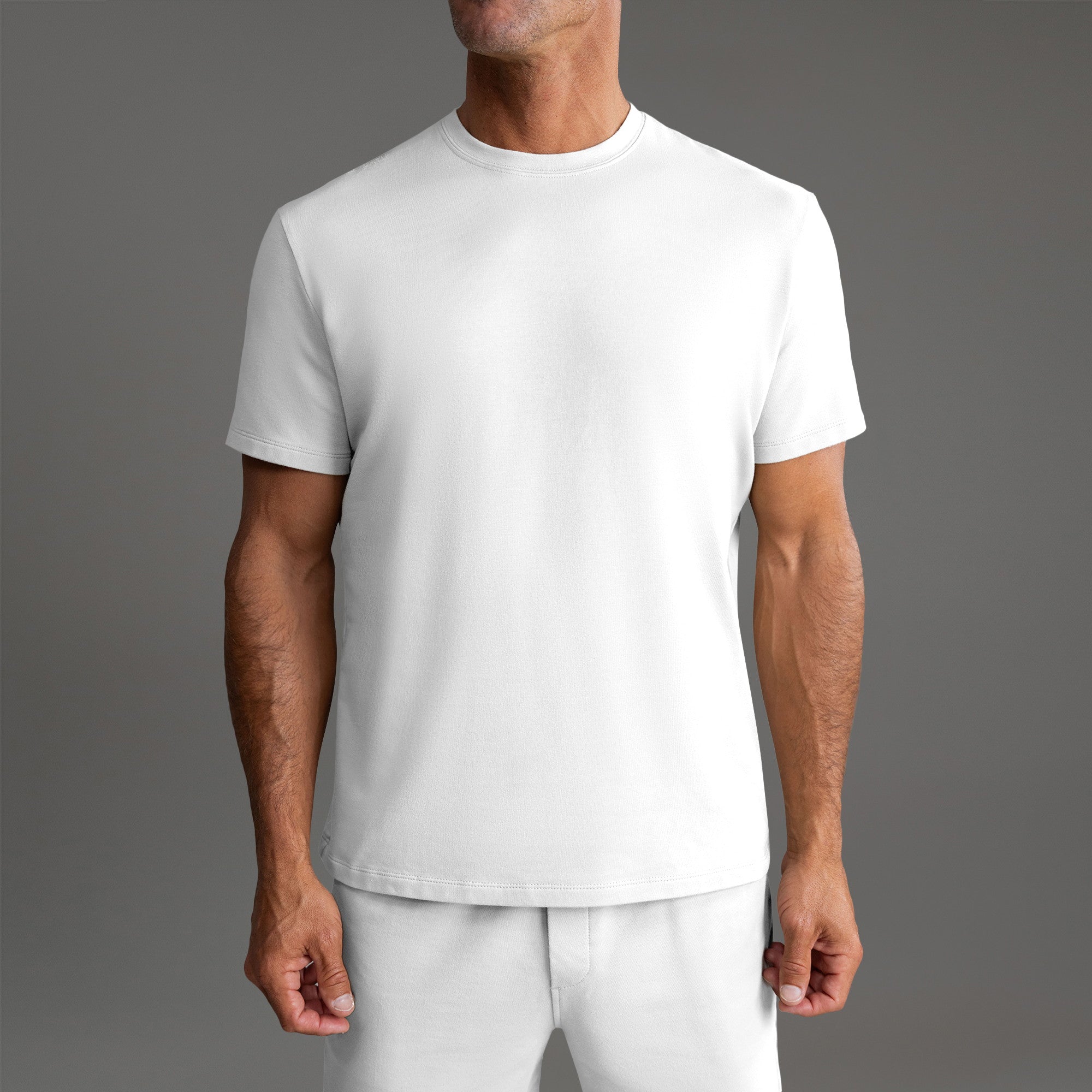 Six t-shirts in Black and White on a beige background model Tyler in Essential