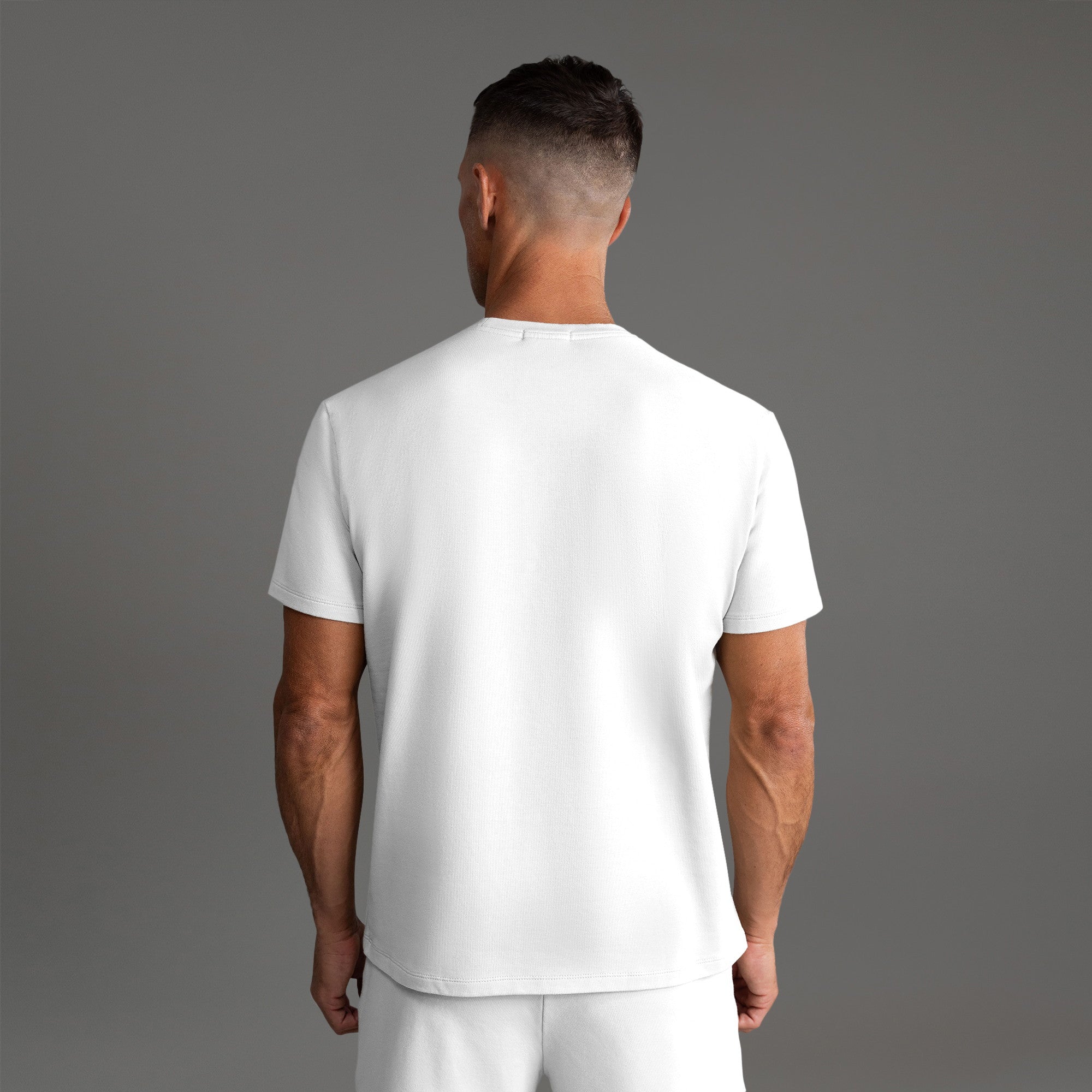 Six t-shirts in Black and White on a beige background model Tyler in Essential