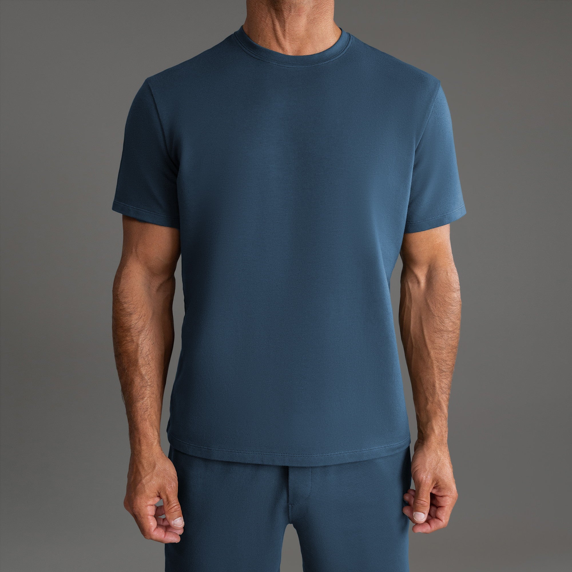 Ten t-shirts in Black, Deep Sea, Moss, Umber, Frost Gray, and White on a beige background model Tyler in Best-Seller