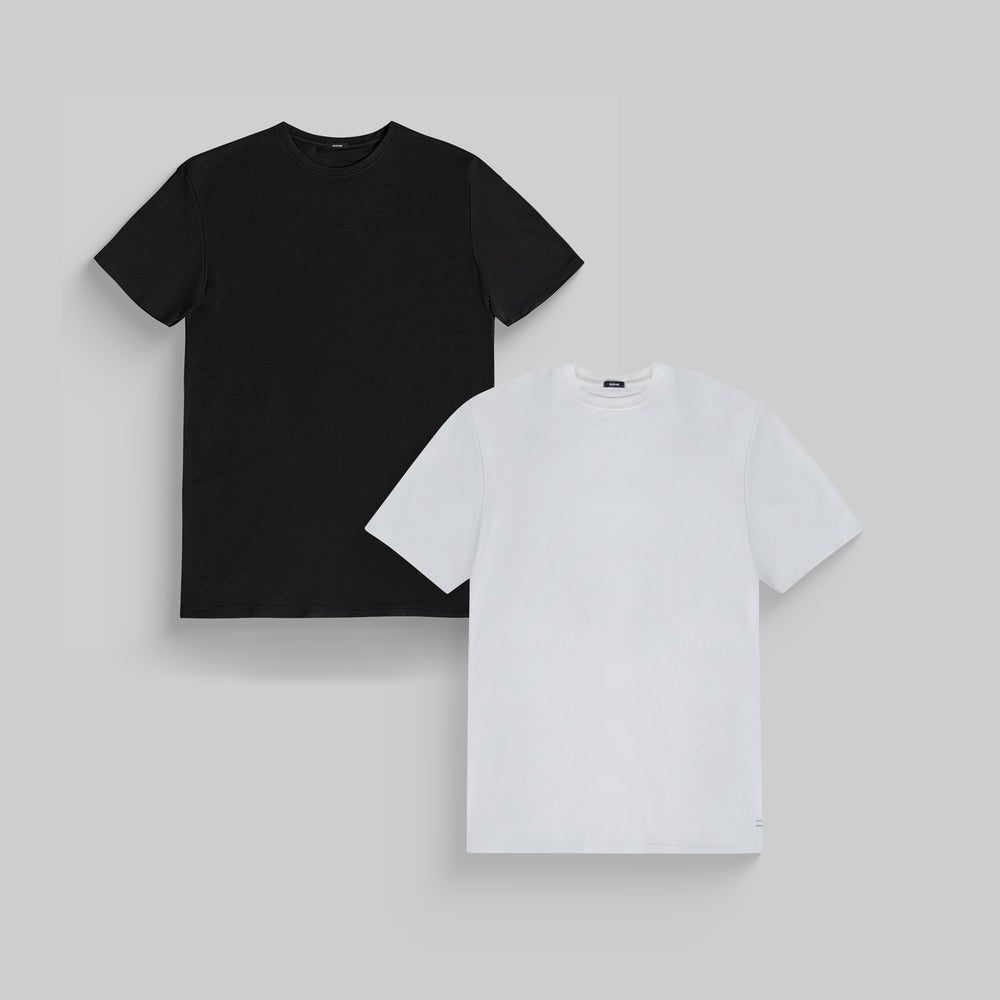 Two plain t-shirts: one black and one white, on a gray background.