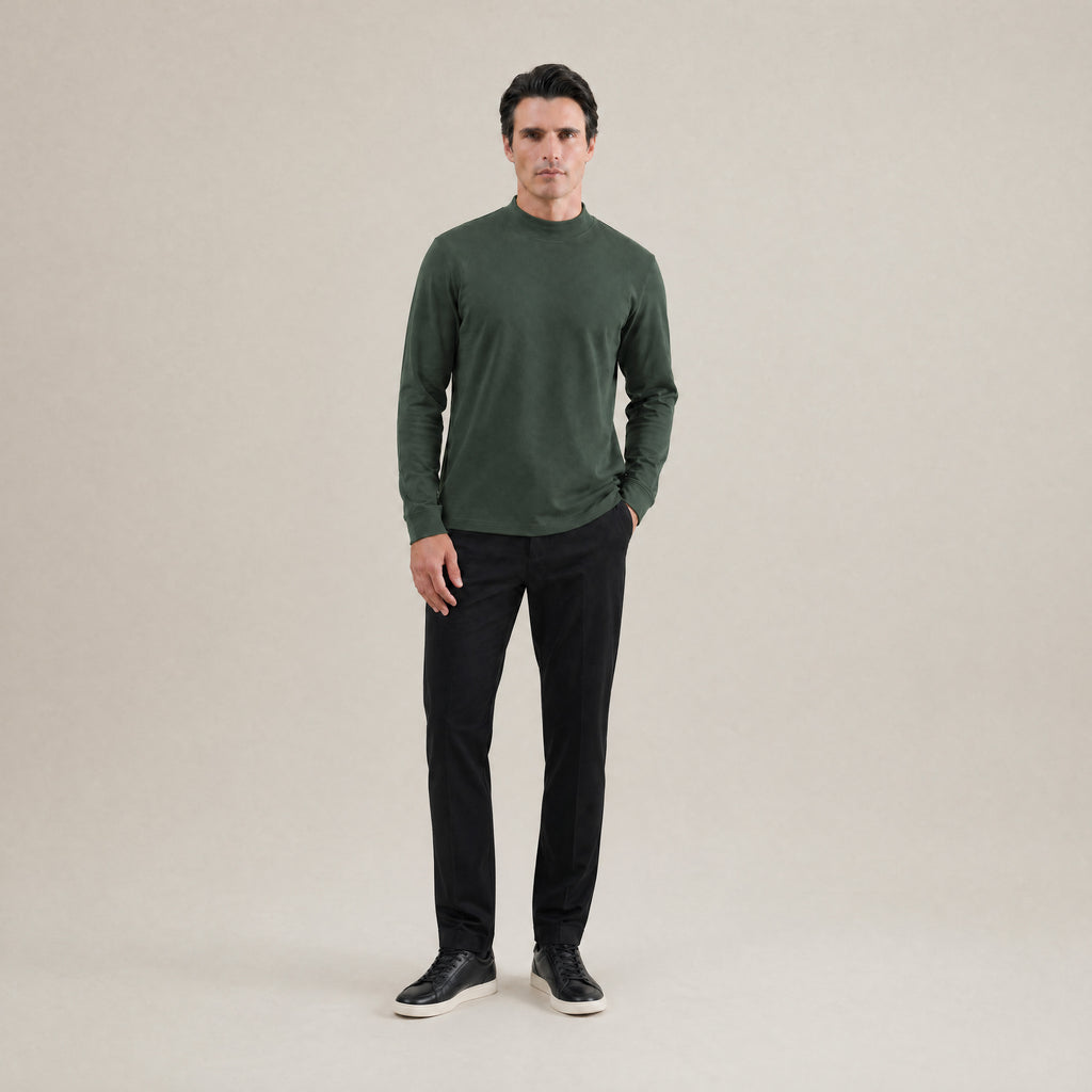 Man wearing a Moss long-sleeve shirt against a beige background model Kive in Moss