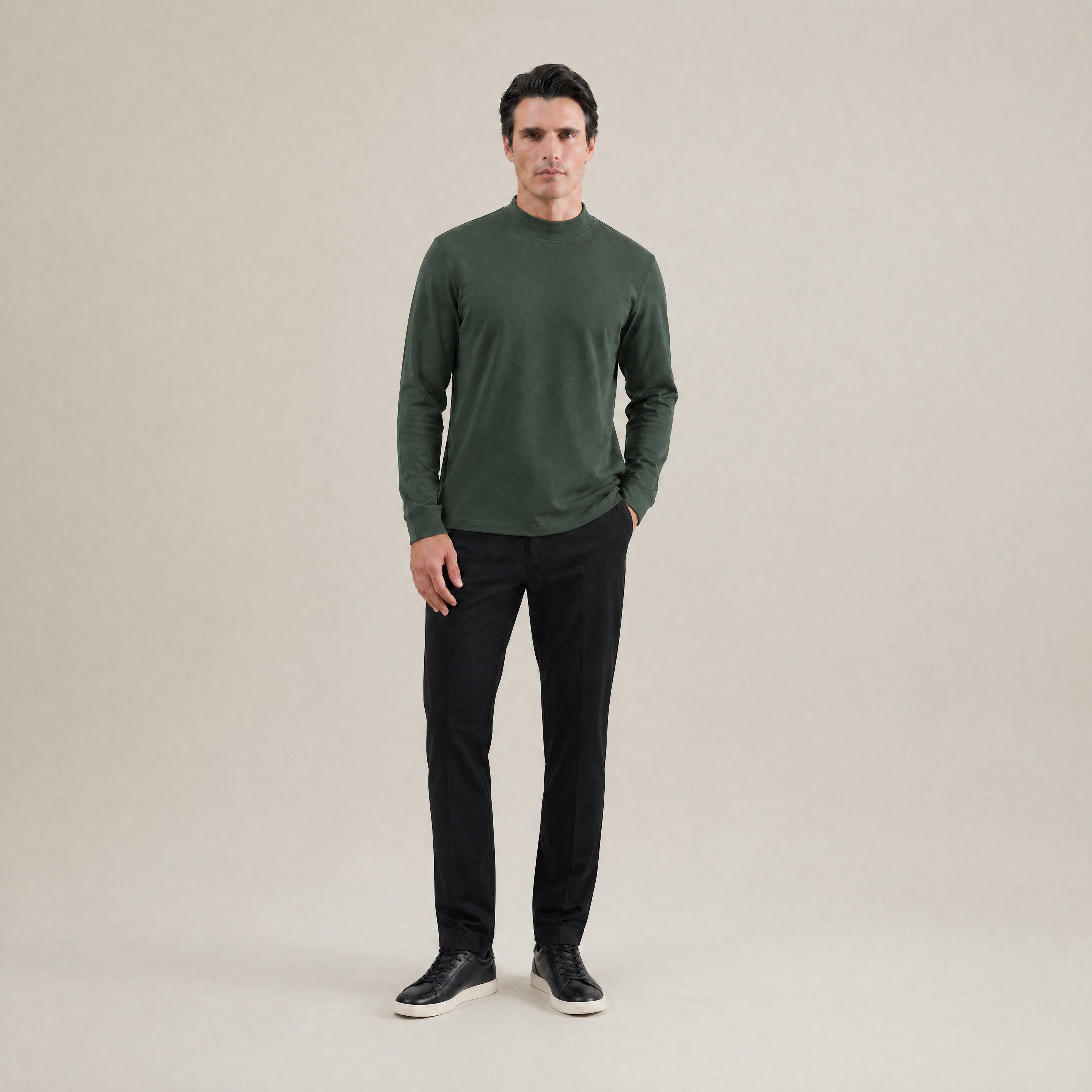 Man wearing a Moss long-sleeve shirt against a beige background model Kive in Moss