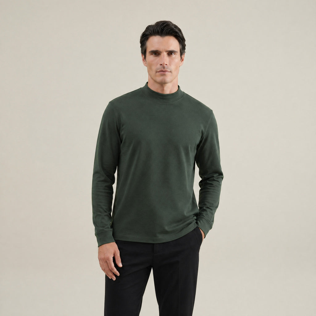 Man wearing a Moss long-sleeve shirt against a beige background model Kive in Moss