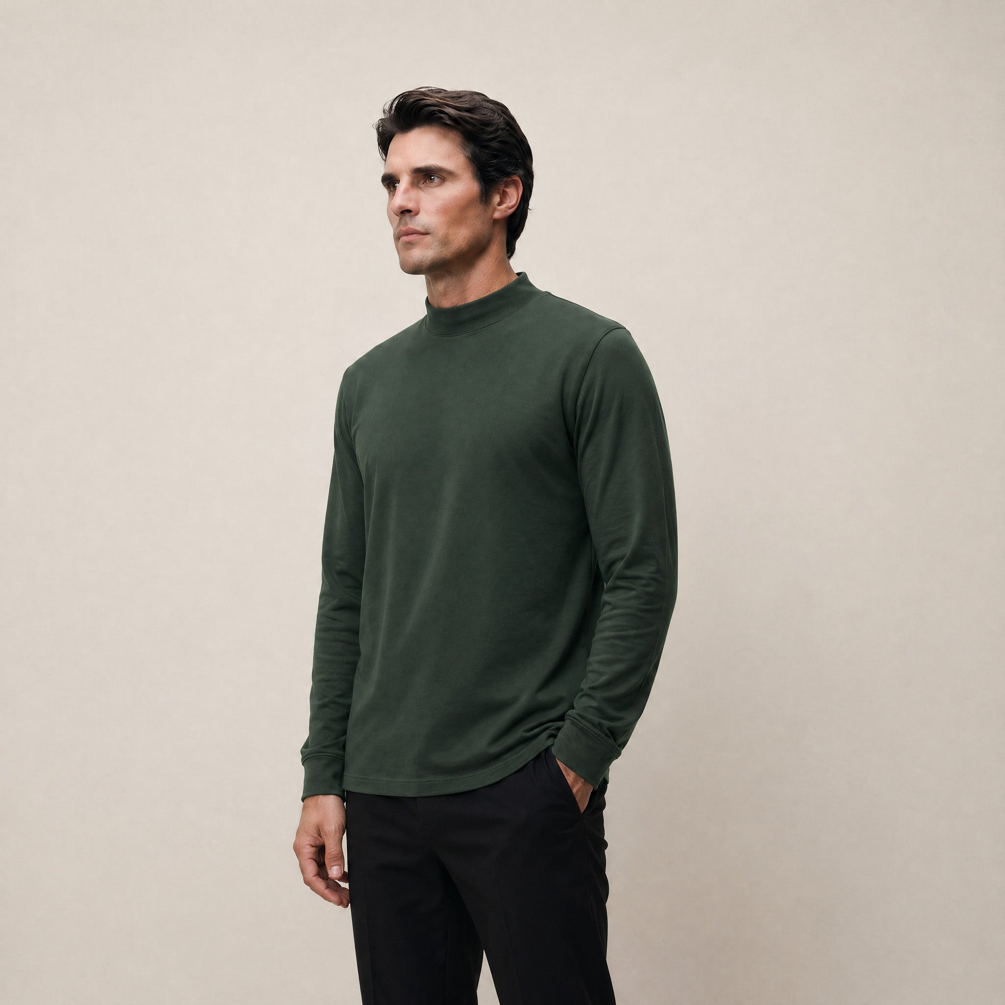 Man wearing a Moss long-sleeve shirt against a beige background model Kive in Moss