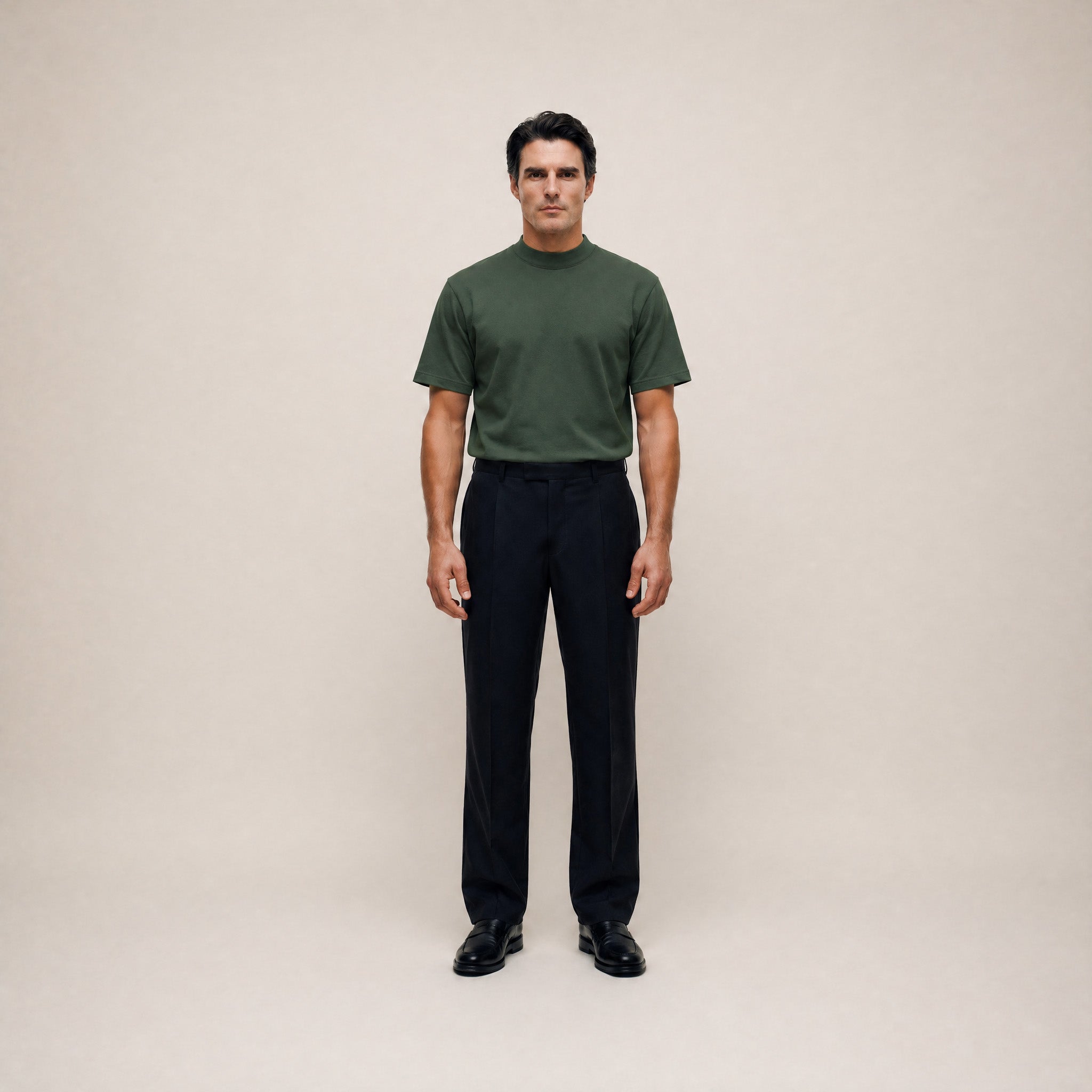 Man wearing a Moss short-sleeve shirt against a beige background model Kive in Moss