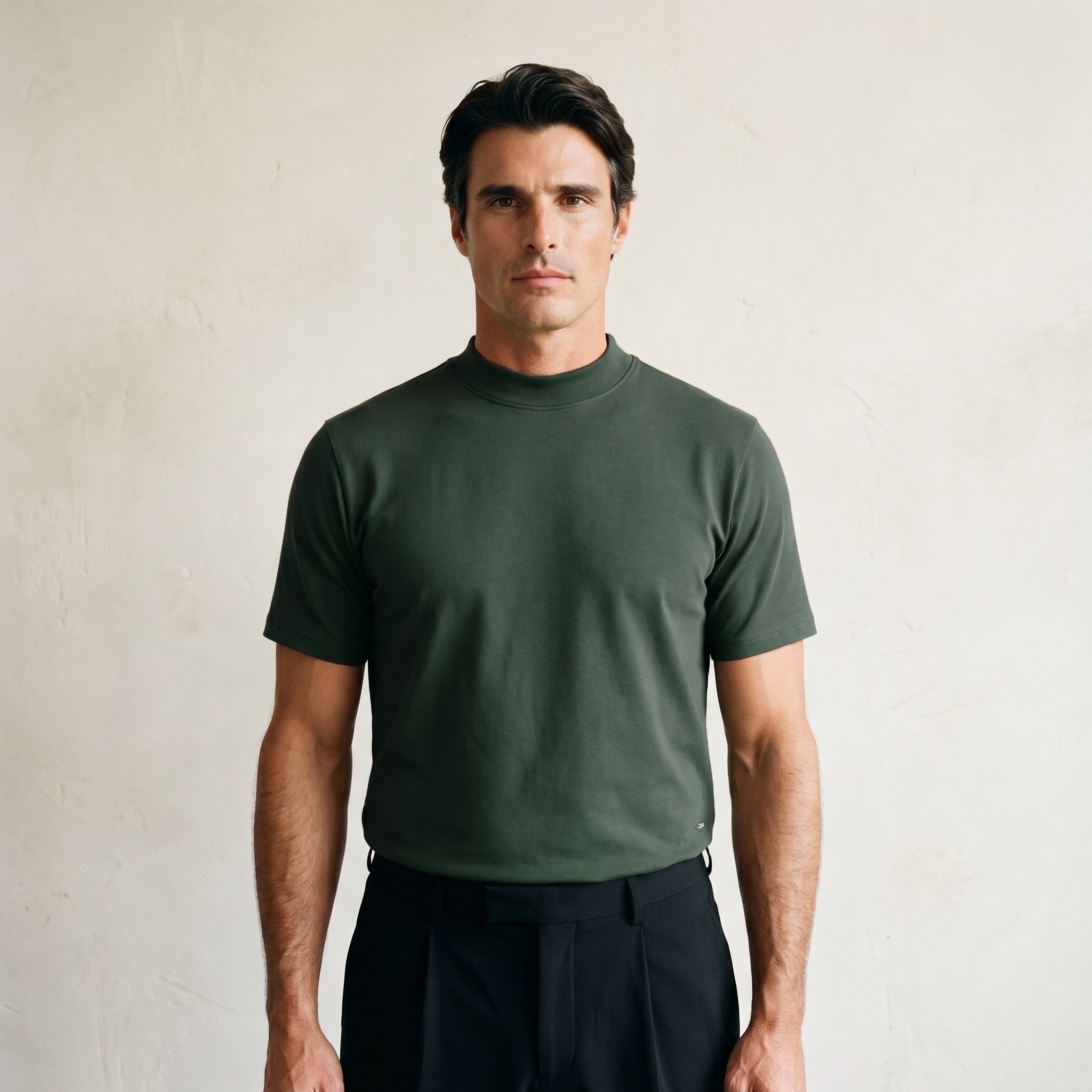 Man wearing a Moss short-sleeve shirt against a beige background model Kive in Moss