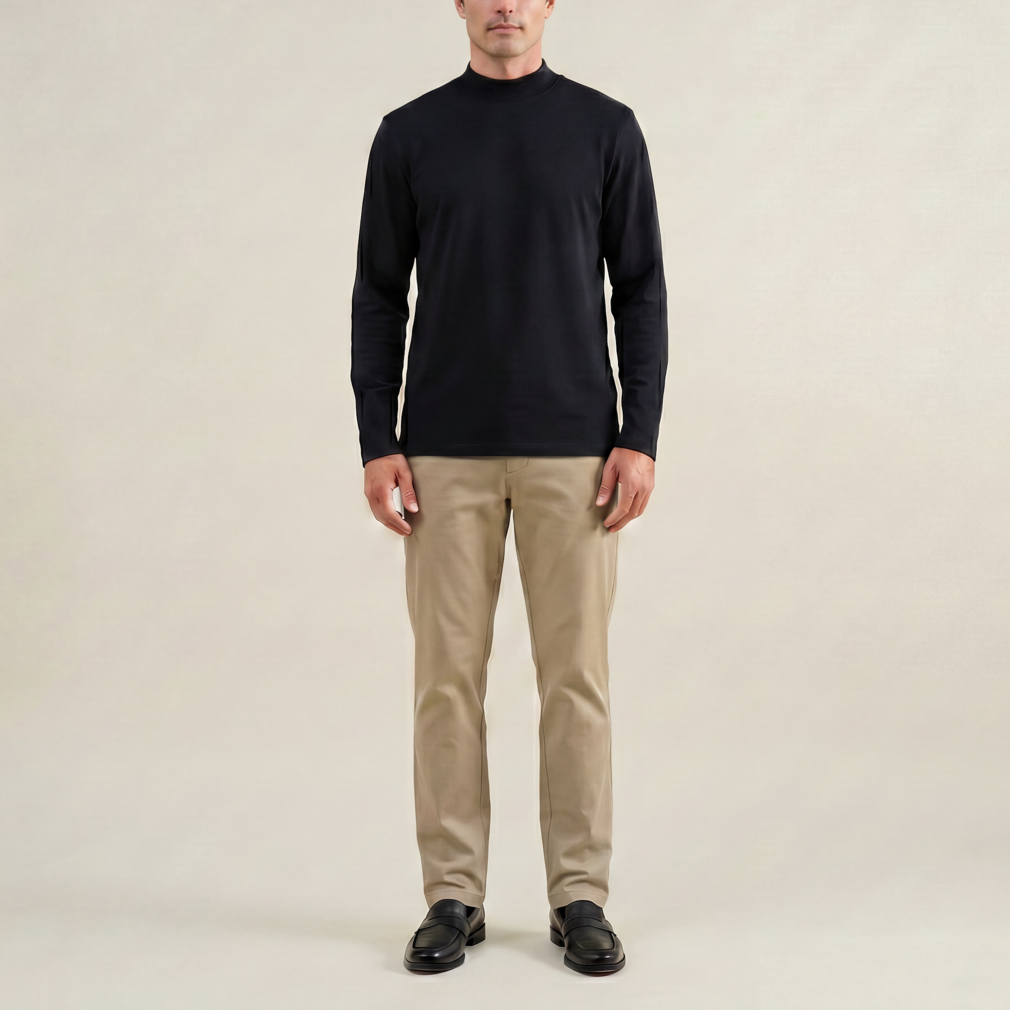 Man wearing a black long-sleeve shirt against a beige background model Kive in black