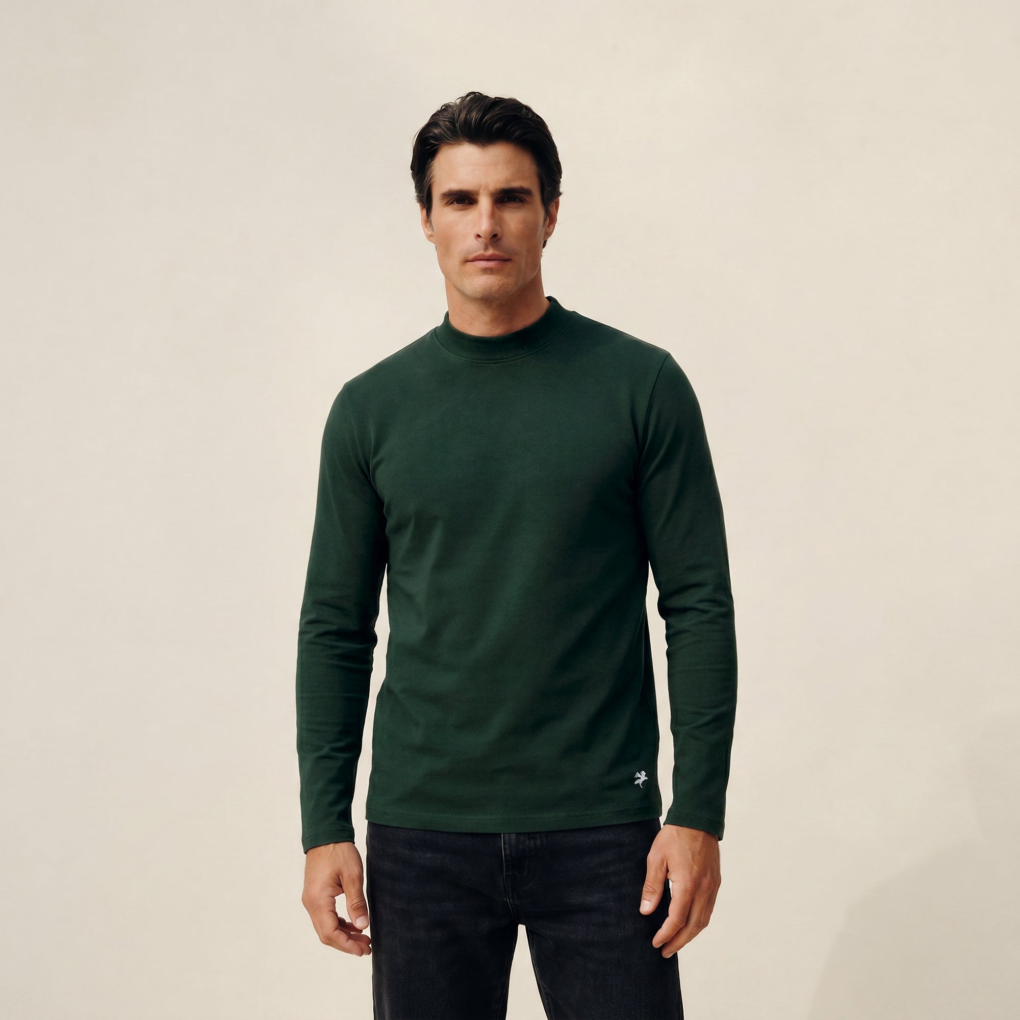 Man wearing a Pine Grove long-sleeve shirt against a beige background model Kive in Pine Grove