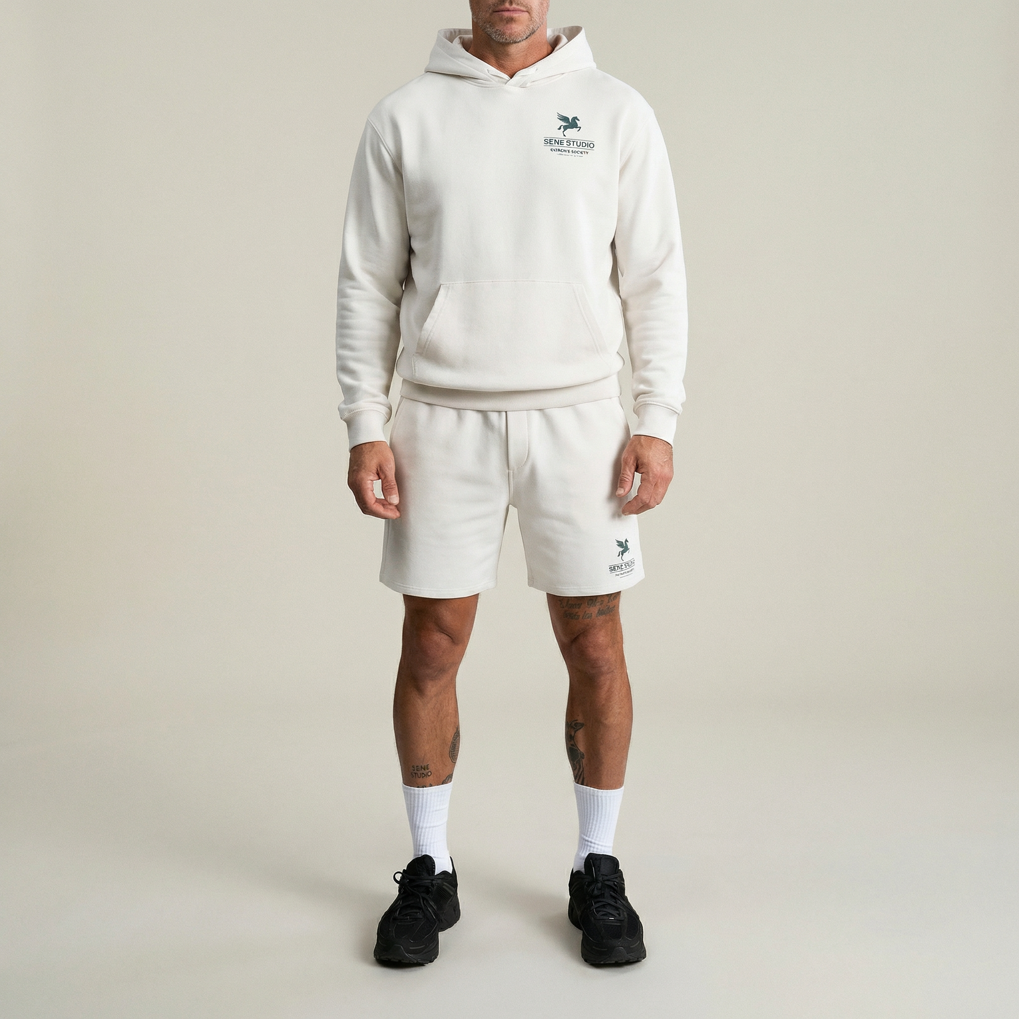 Person wearing black shorts with a logo on a plain background model Kive in Bone