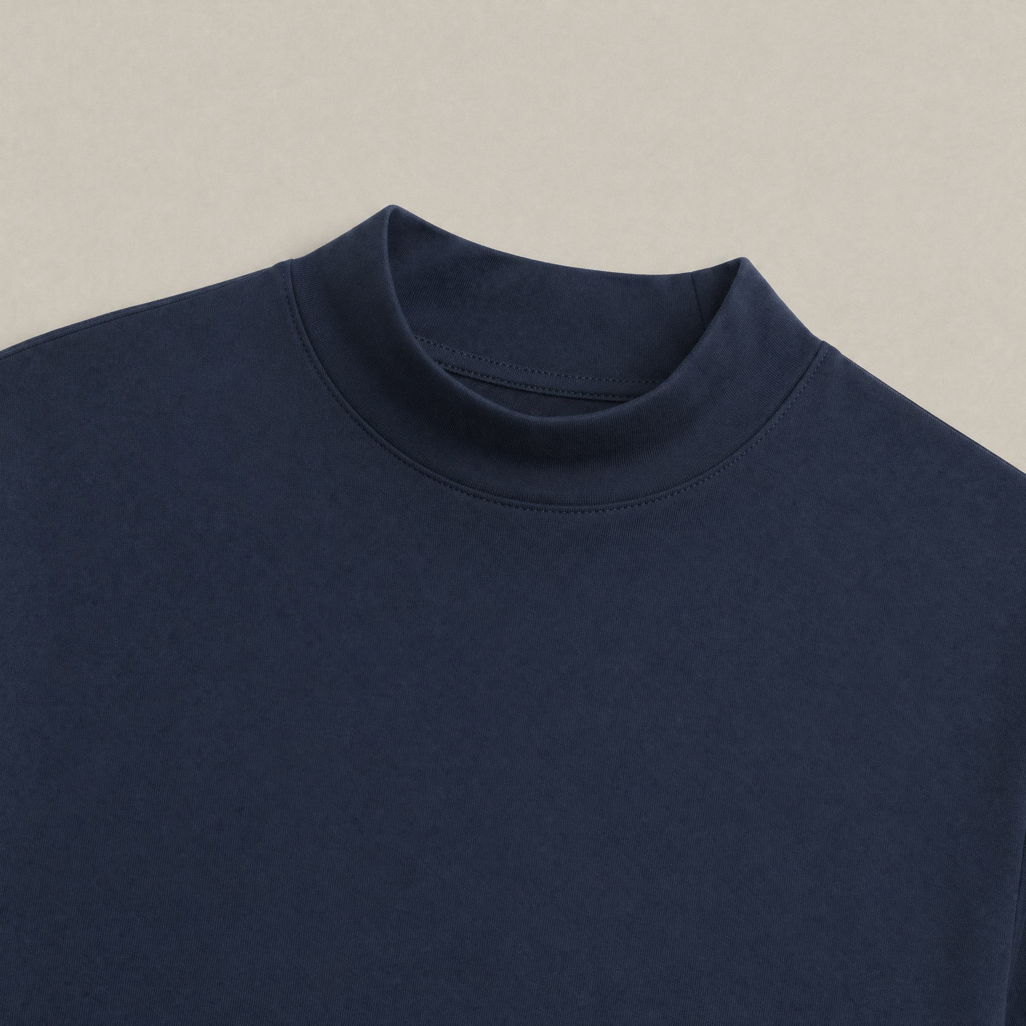 Close up of Deep Sea mockneck long-sleeve shirt in Deep Sea with beige background model Kive in Deep Sea