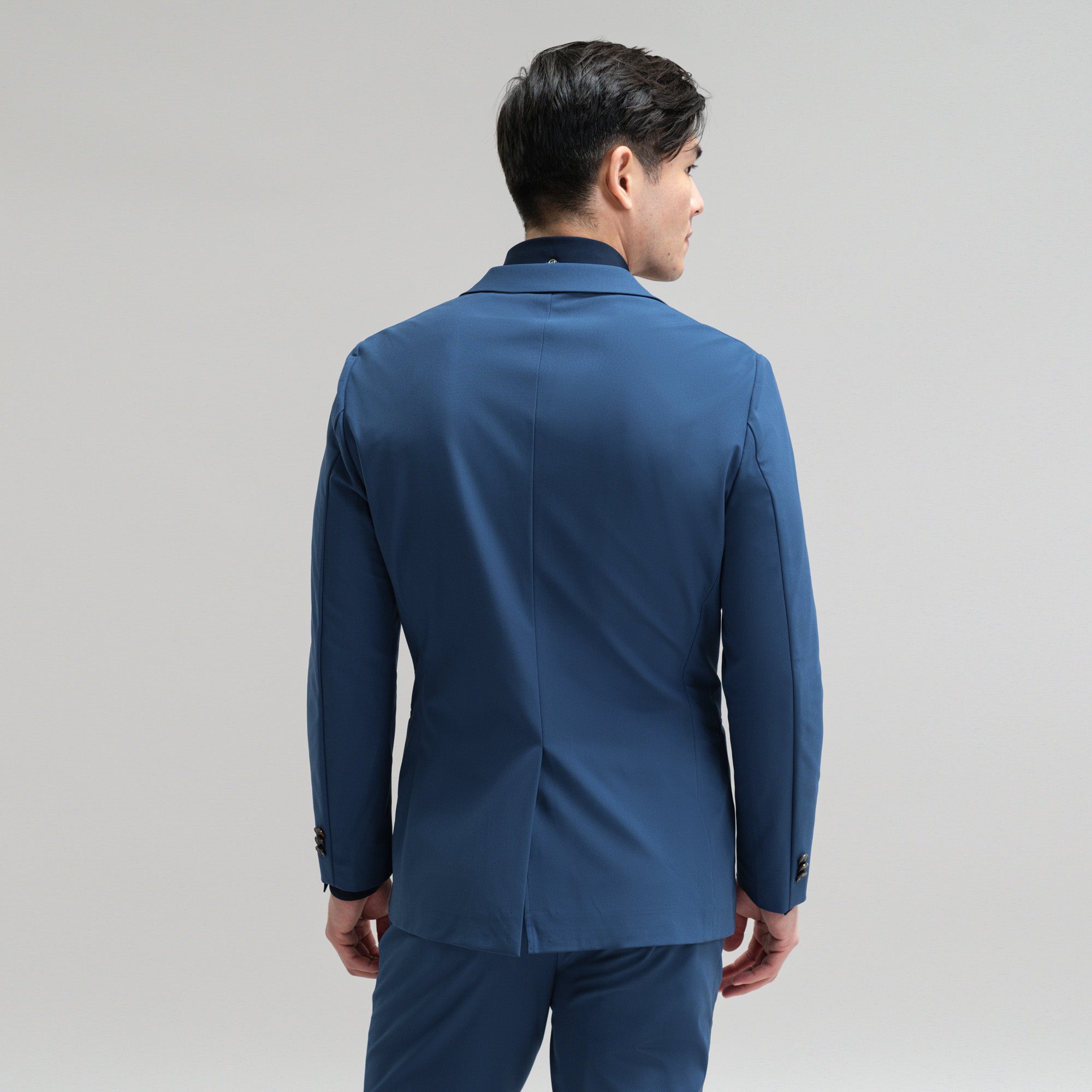 Bespoke custom athleisure technical athletic stretch suit los angeles model Jesse in Italian Blue