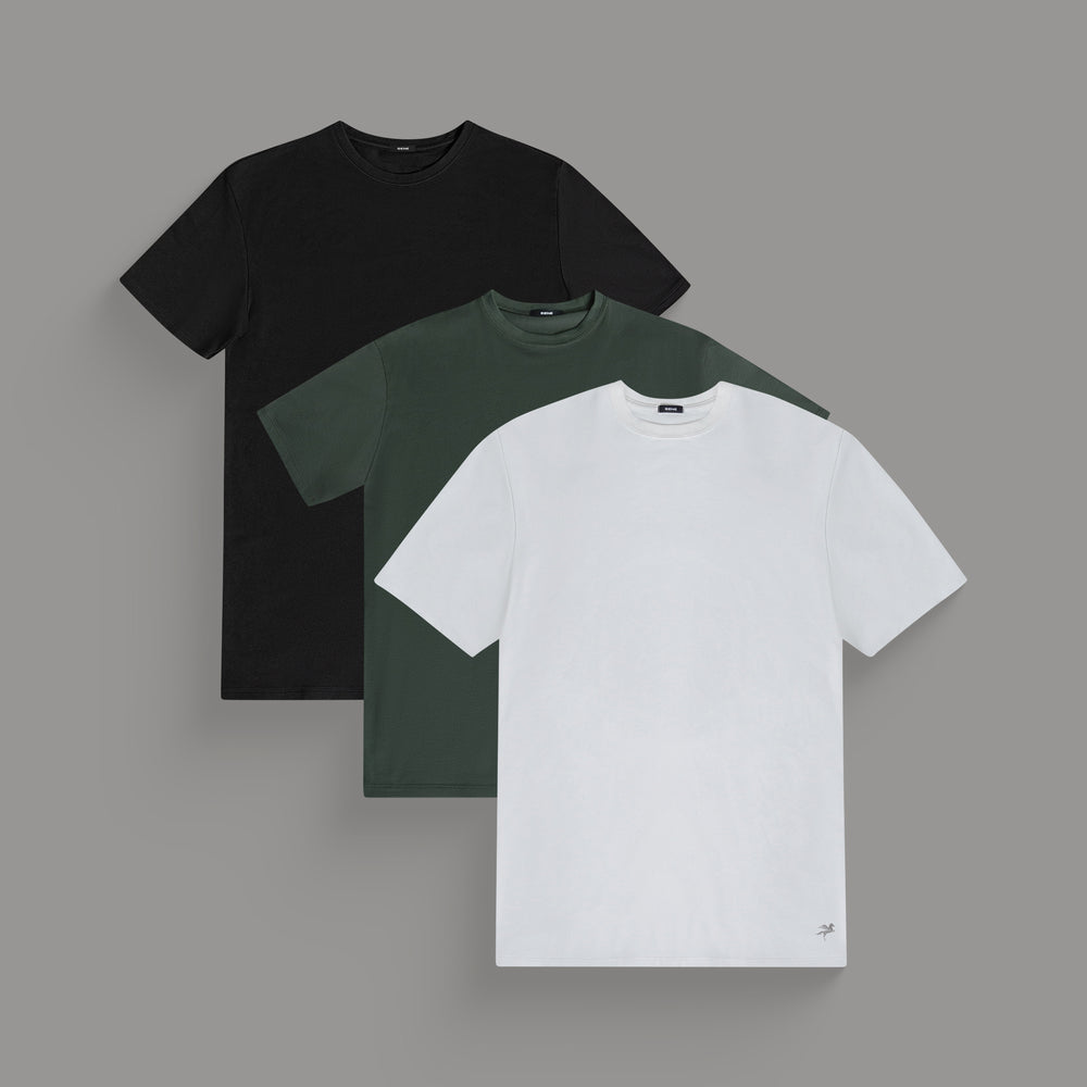 Three plain t-shirts in black, green, and white, layered front to back.