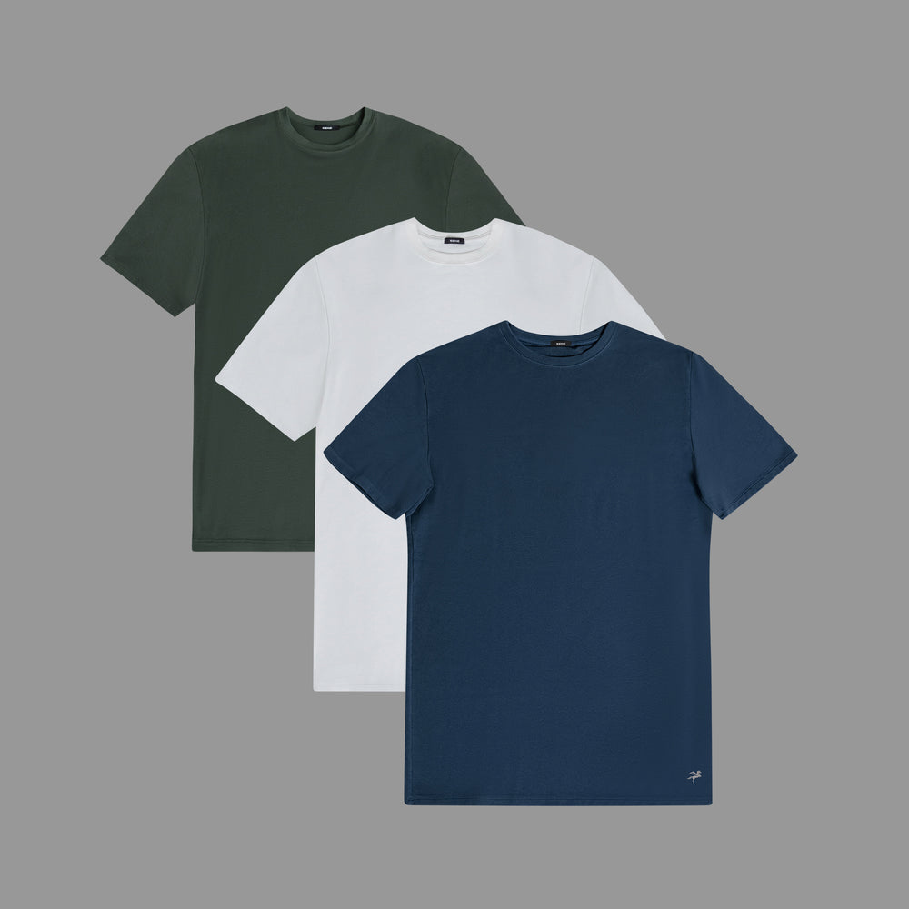 Three t-shirts in green, white, and navy blue on a gray background.