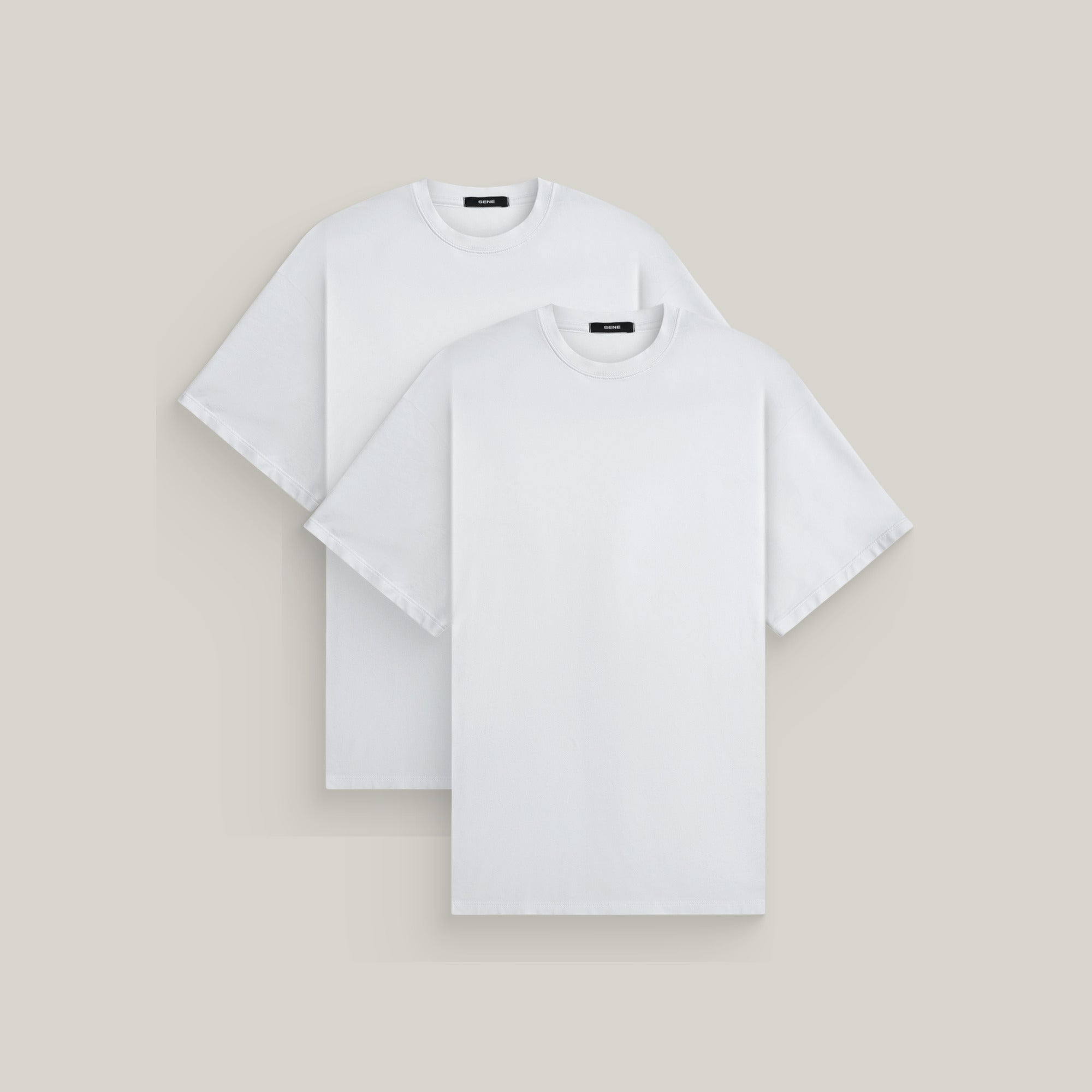 Two oversized t-shirts in white on a beige background model Kive in All-White