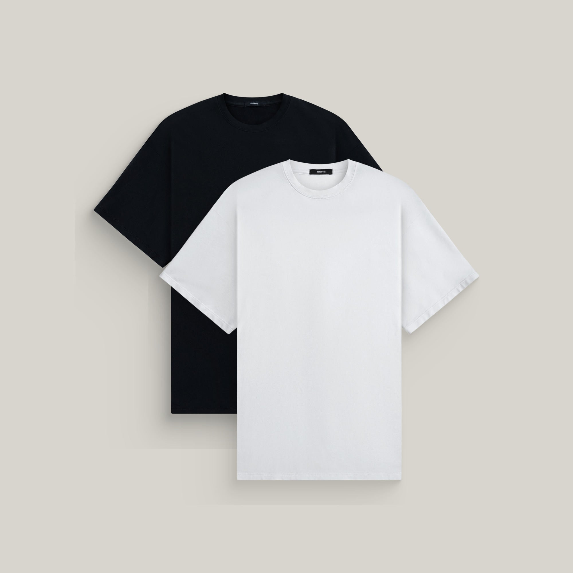 Two oversized t-shirts in black and white on a beige background model Kive in Minimalist